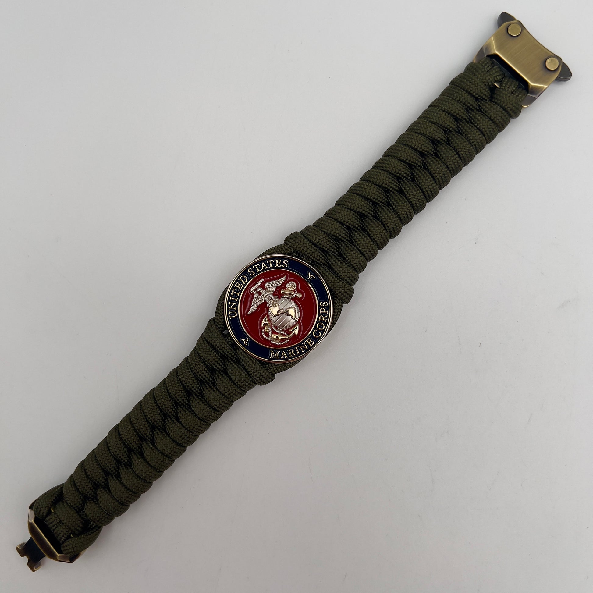 Thick, semi-rigid and comfortable braided United States Marine Corps bracelet featuring a 24K gold and silver plated USMC officer Eagle Globe and Anchor medallion, a gold Cobra style tactical buckle and woven with olive drab 550 paracord.