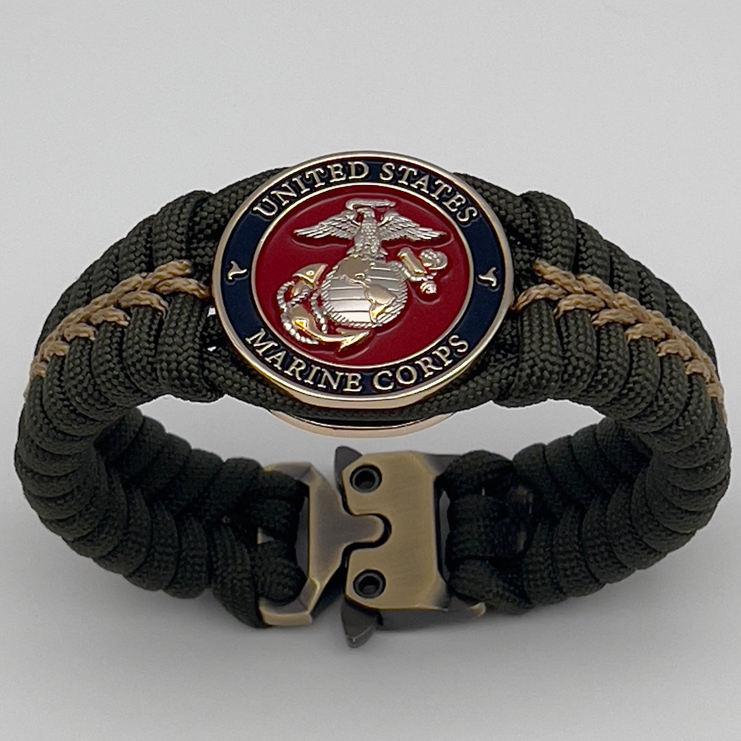 Thick, semi-rigid and comfortable braided United States Marine Corps bracelet featuring a 24K gold and silver plated USMC officer Eagle Globe and Anchor medallion, a gold Cobra style tactical buckle and woven with olive drab 550 and gold micro paracord.
