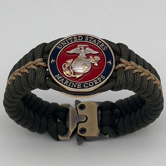 Thick, semi-rigid and comfortable braided United States Marine Corps bracelet featuring a 24K gold and silver plated USMC officer Eagle Globe and Anchor medallion, a gold Cobra style tactical buckle and woven with olive drab 550 and gold micro paracord.