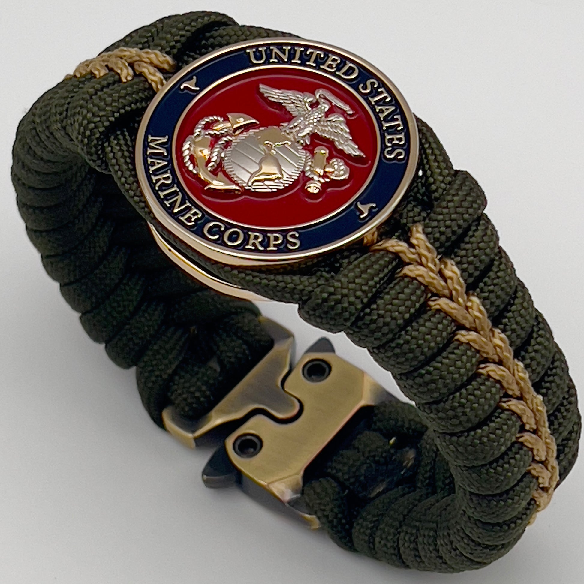 Thick, semi-rigid and comfortable braided United States Marine Corps bracelet featuring a 24K gold and silver plated USMC officer Eagle Globe and Anchor medallion, a gold Cobra style tactical buckle and woven with olive drab 550 and gold micro paracord.