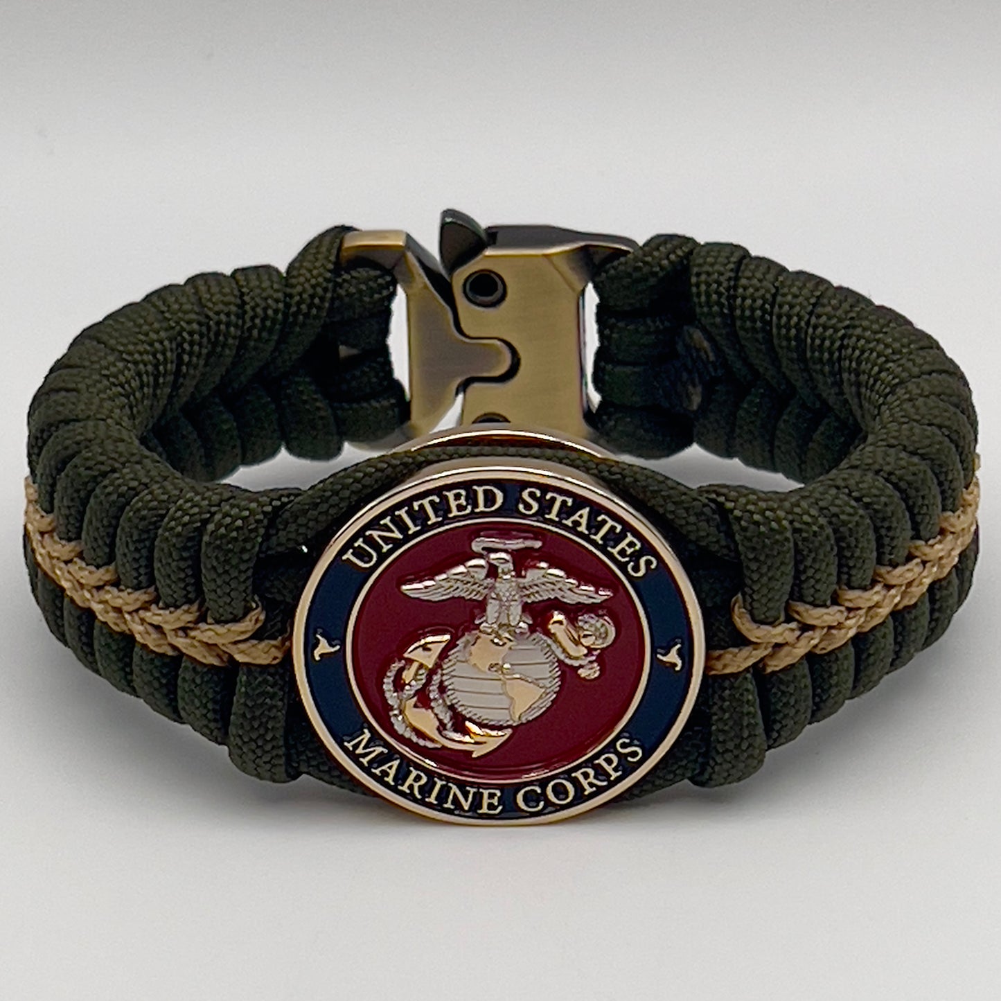 Thick, semi-rigid and comfortable braided United States Marine Corps bracelet featuring a 24K gold and silver plated USMC officer Eagle Globe and Anchor medallion, a gold Cobra style tactical buckle and woven with olive drab 550 and gold micro paracord.