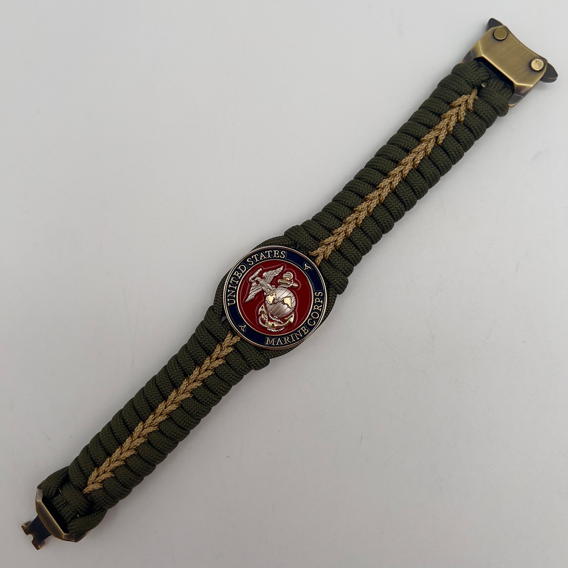 Thick, semi-rigid and comfortable braided United States Marine Corps bracelet featuring a 24K gold and silver plated USMC officer Eagle Globe and Anchor medallion, a gold Cobra style tactical buckle and woven with olive drab 550 and gold micro paracord.