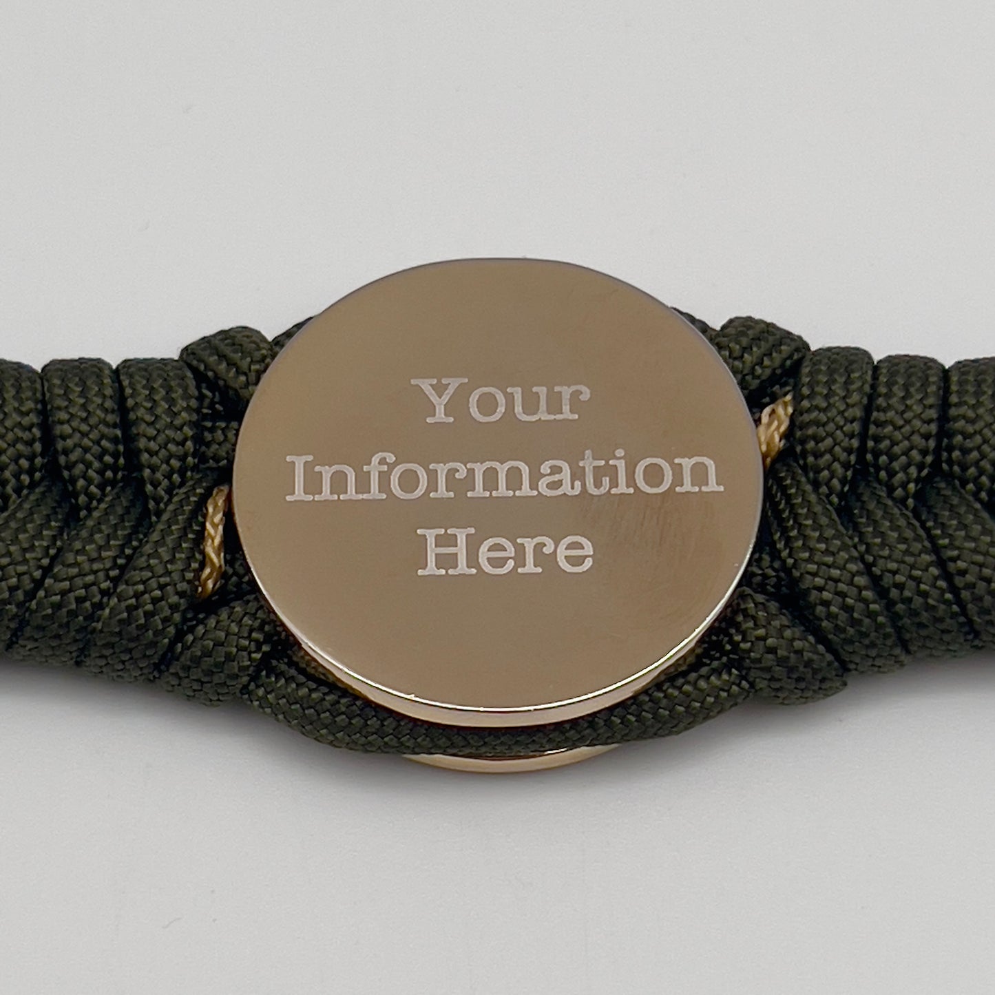 Thick, semi-rigid and comfortable braided United States Marine Corps bracelet featuring a 24K gold and silver plated USMC officer Eagle Globe and Anchor medallion, a gold Cobra style tactical buckle and woven with olive drab 550 and gold micro paracord.