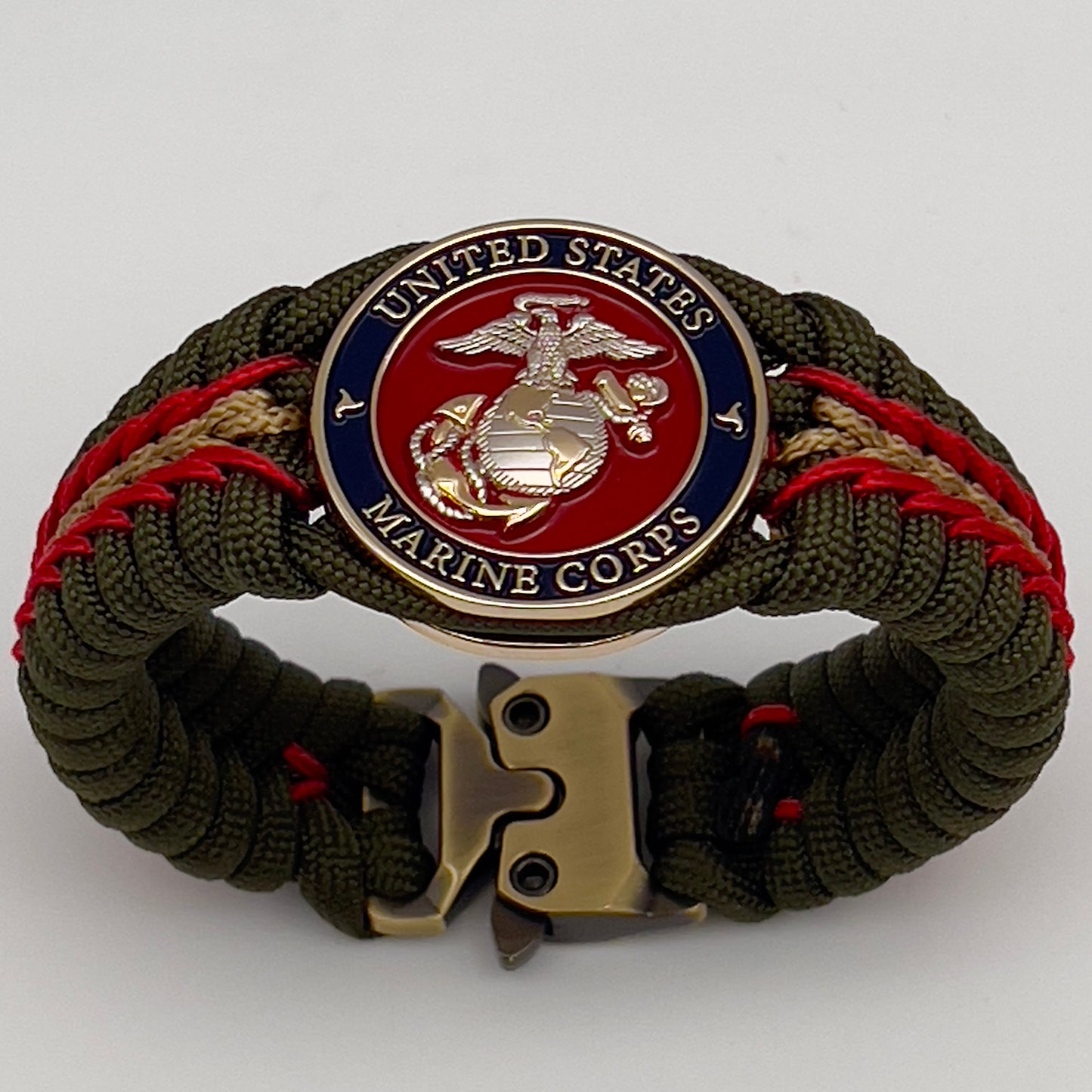 Thick, semi-rigid and comfortable braided United States Marine Corps bracelet featuring a 24K gold and silver plated USMC officer Eagle Globe and Anchor medallion, a gold Cobra style tactical buckle and woven with olive drab 550 and gold micro paracord.