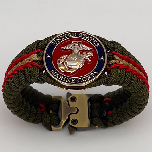 Thick, semi-rigid and comfortable braided United States Marine Corps bracelet featuring a 24K gold and silver plated USMC officer Eagle Globe and Anchor medallion, a gold Cobra style tactical buckle and woven with olive drab 550 and gold micro paracord.