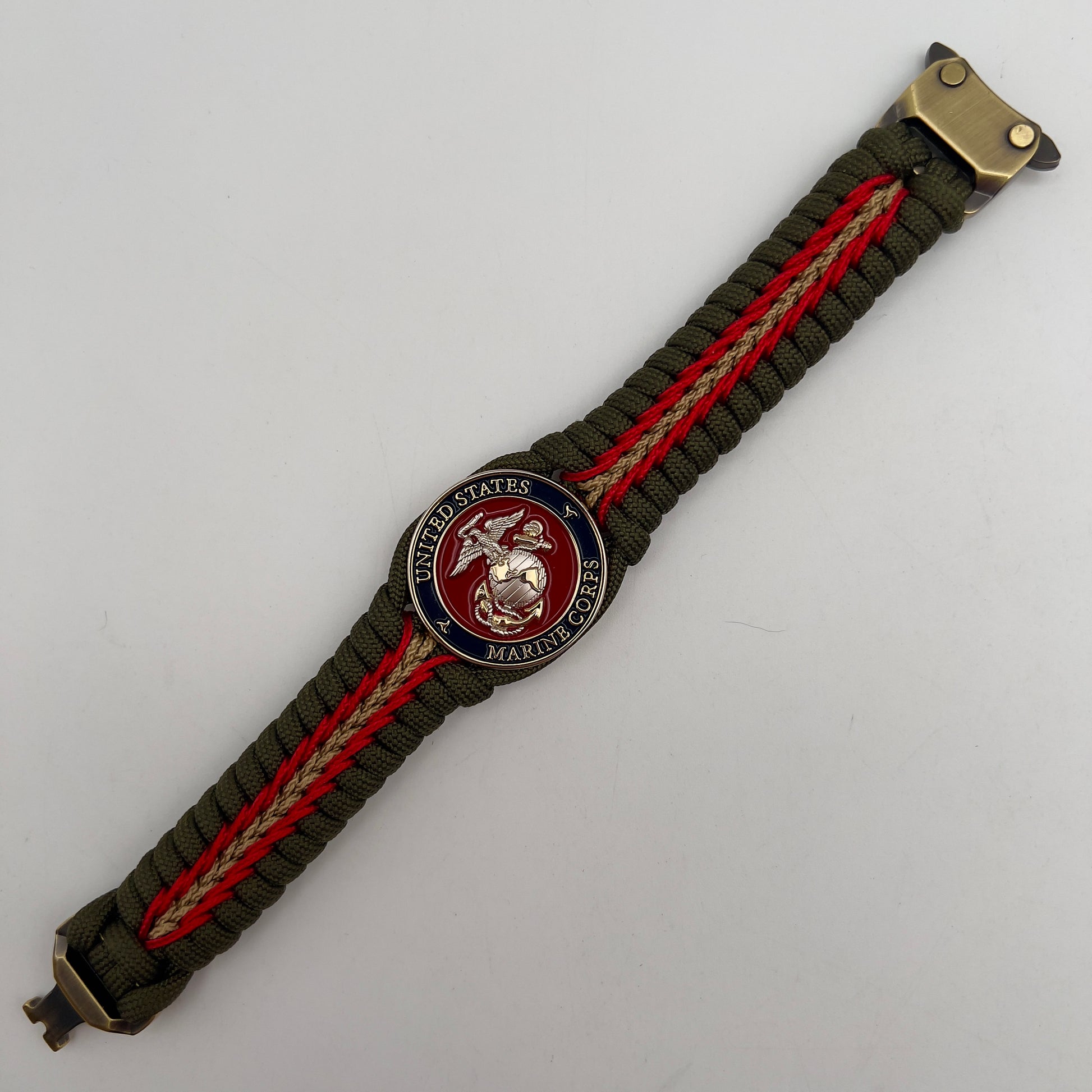Thick, semi-rigid and comfortable braided United States Marine Corps bracelet featuring a 24K gold and silver plated USMC officer Eagle Globe and Anchor medallion, a gold Cobra style tactical buckle and woven with olive drab 550 and gold micro paracord.
