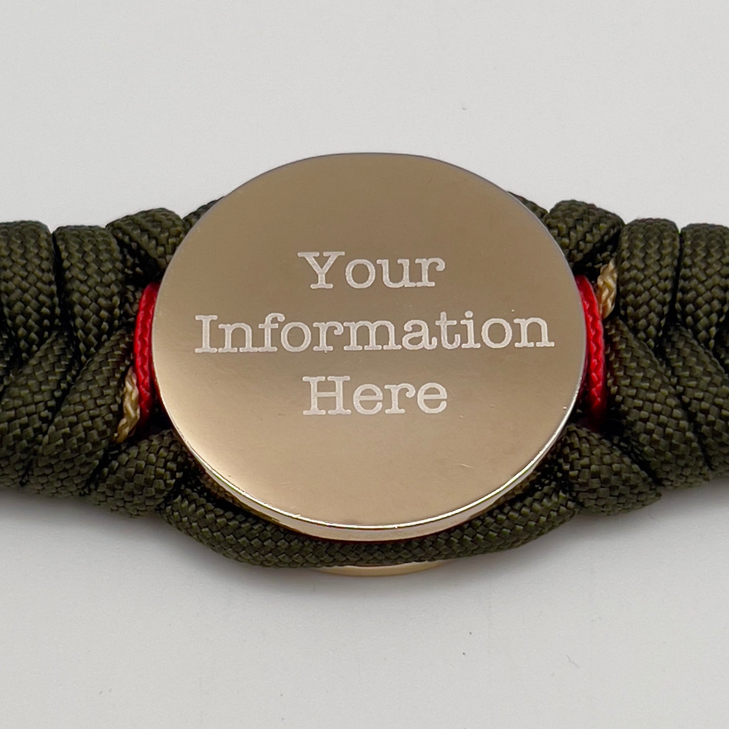 Thick, semi-rigid and comfortable braided United States Marine Corps bracelet featuring a 24K gold and silver plated USMC officer Eagle Globe and Anchor medallion, a gold Cobra style tactical buckle and woven with olive drab 550 and gold micro paracord.