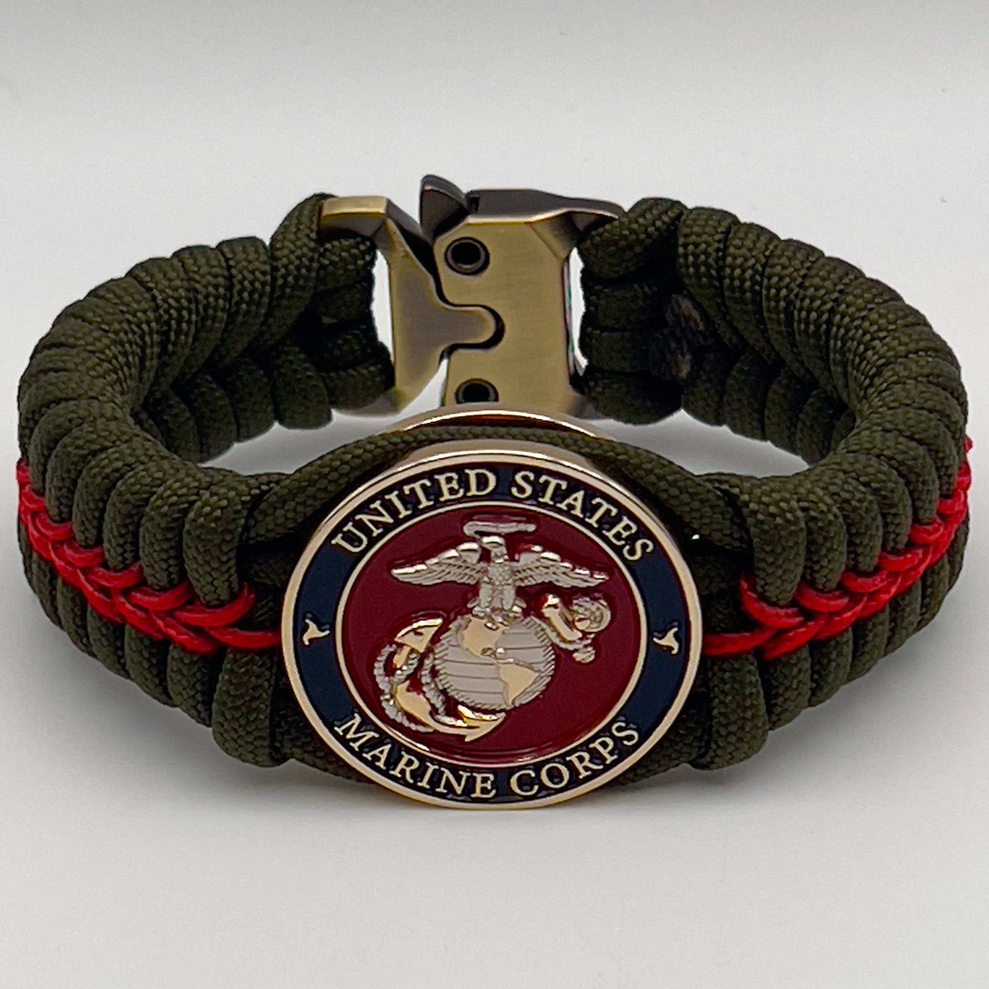 Thick, semi-rigid and comfortable braided United States Marine Corps bracelet featuring a 24K gold and silver plated USMC officer Eagle Globe and Anchor medallion, a gold Cobra style tactical buckle and woven with olive drab 550 and Imperial red micro paracord.