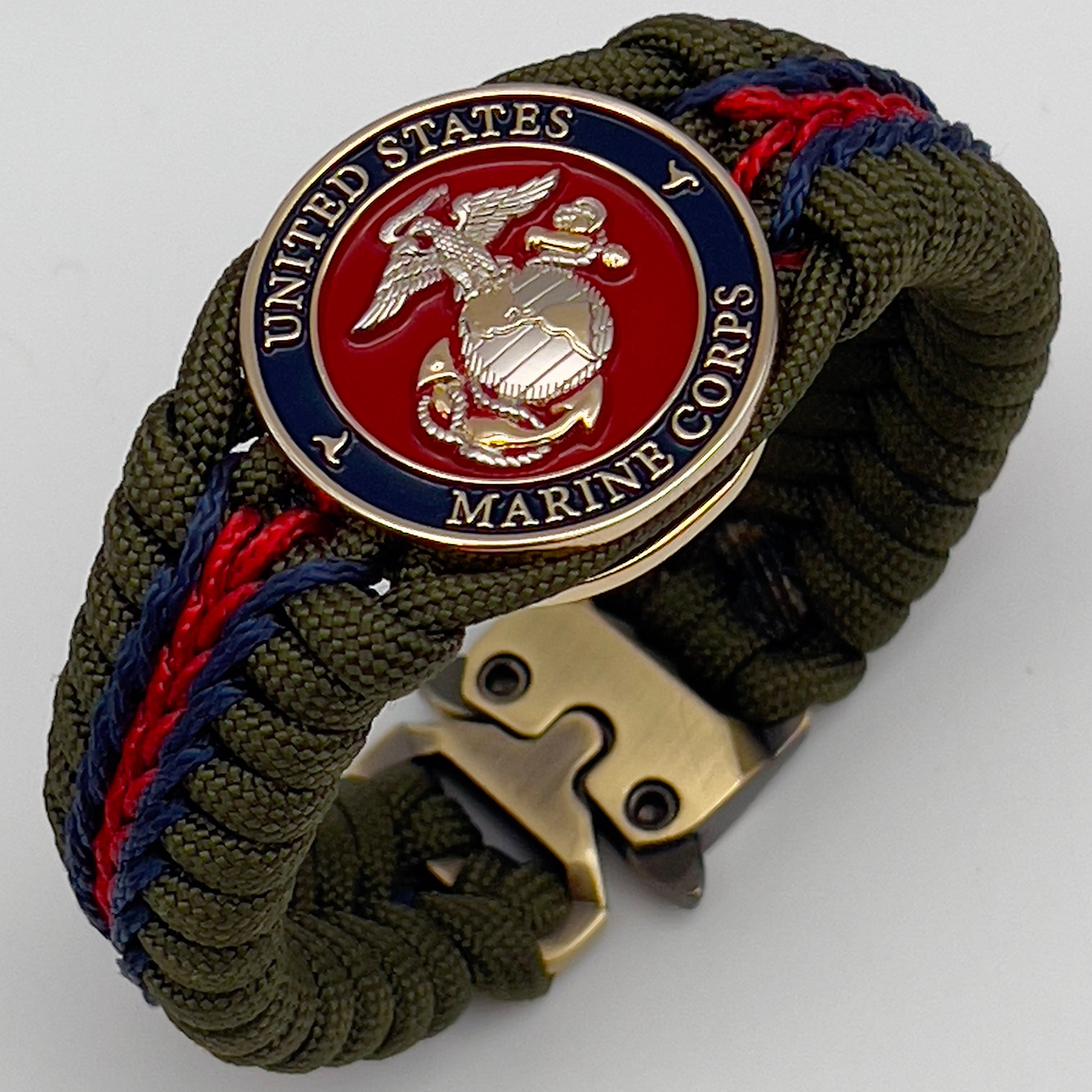 Thick, semi-rigid and comfortable braided United States Marine Corps bracelet featuring a 24K gold and silver plated USMC officer Eagle Globe and Anchor medallion, a gold Cobra style tactical buckle and woven with olive drab 550 and Imperial red and gold micro paracord.