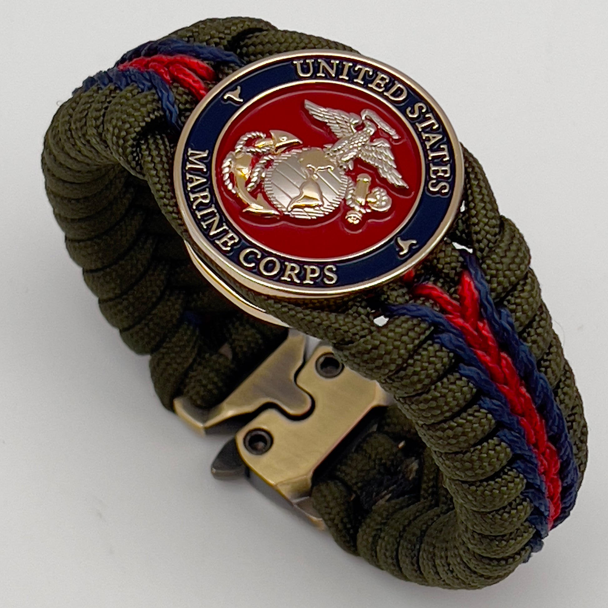 Thick, semi-rigid and comfortable braided United States Marine Corps bracelet featuring a 24K gold and silver plated USMC officer Eagle Globe and Anchor medallion, a gold Cobra style tactical buckle and woven with olive drab 550 and Imperial red and gold micro paracord.