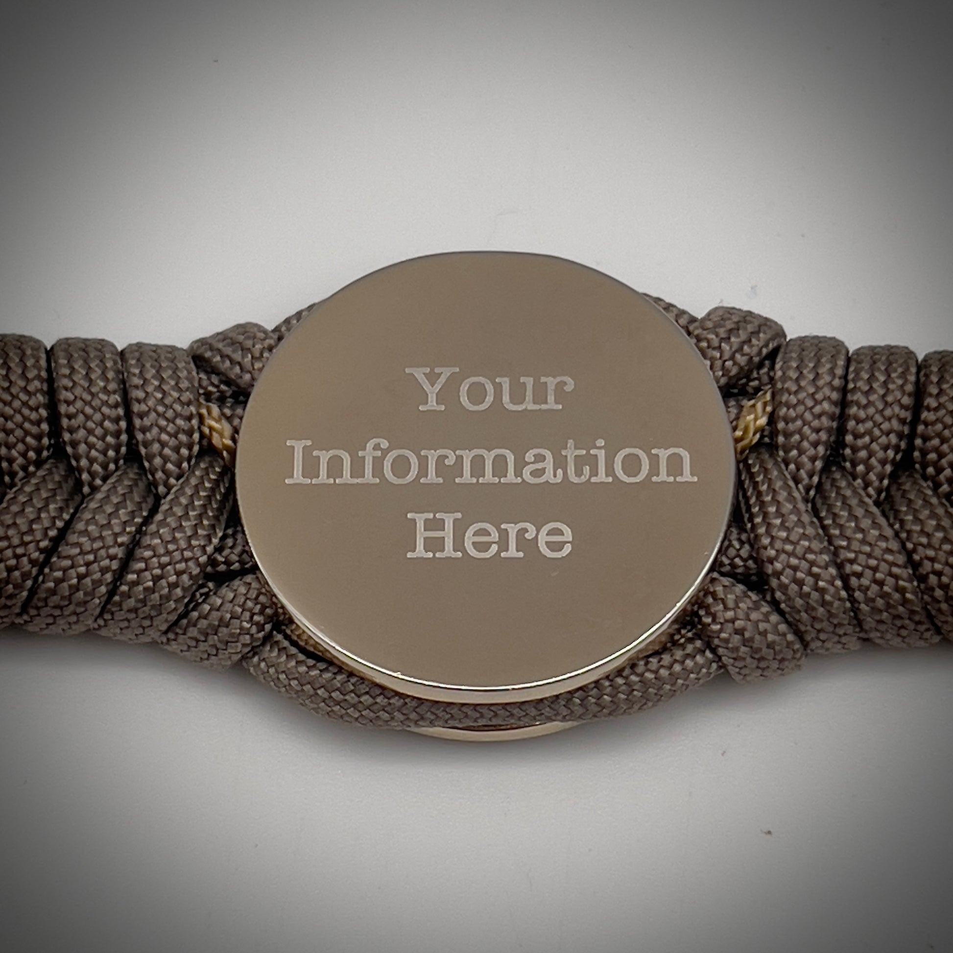 Thick, semi-rigid and comfortable braided United States Marine Corps bracelet featuring a 24K gold and silver plated USMC officer Eagle Globe and Anchor medallion, a gold Cobra style tactical buckle and woven with tan 550 paracord and gold micro cord.