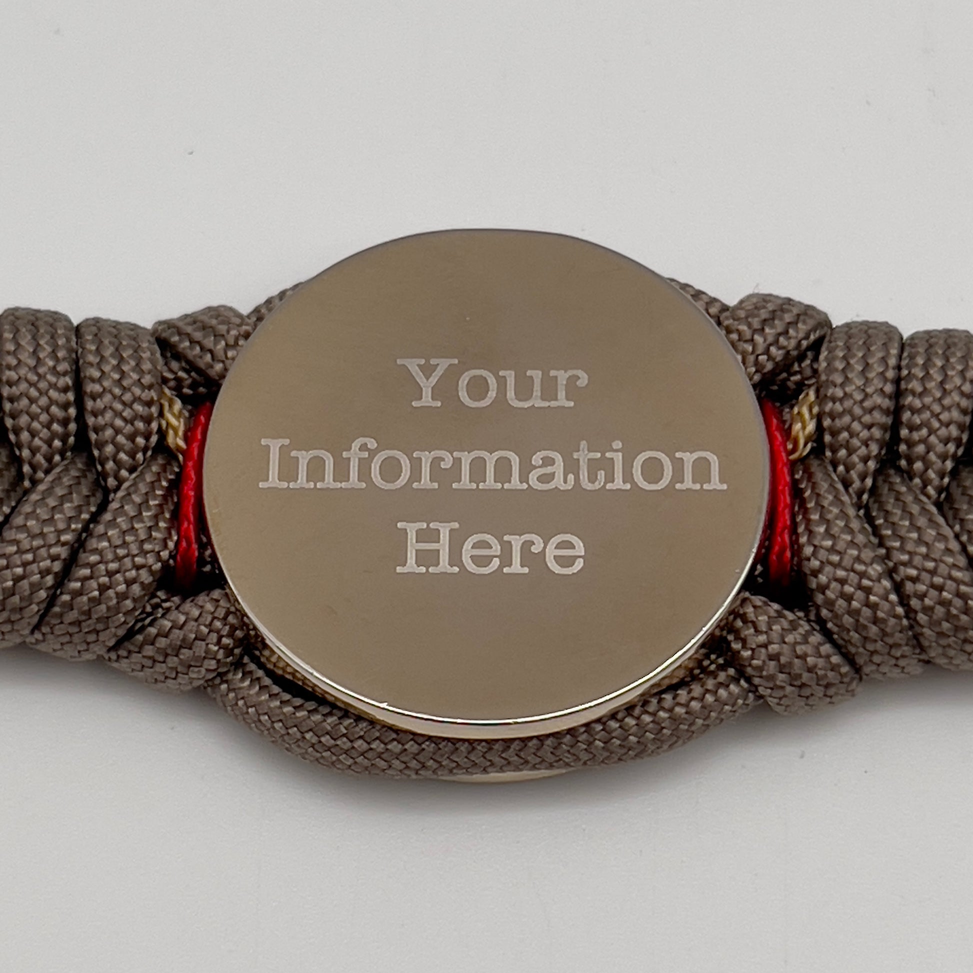 Thick and comfortable braided United States Marine Corps bracelet featuring a 24K gold and silver plated USMC officer Eagle Globe and Anchor medallion, a Cobra style tactical buckle and woven with tan 550, Imperial red and gold micro paracord.