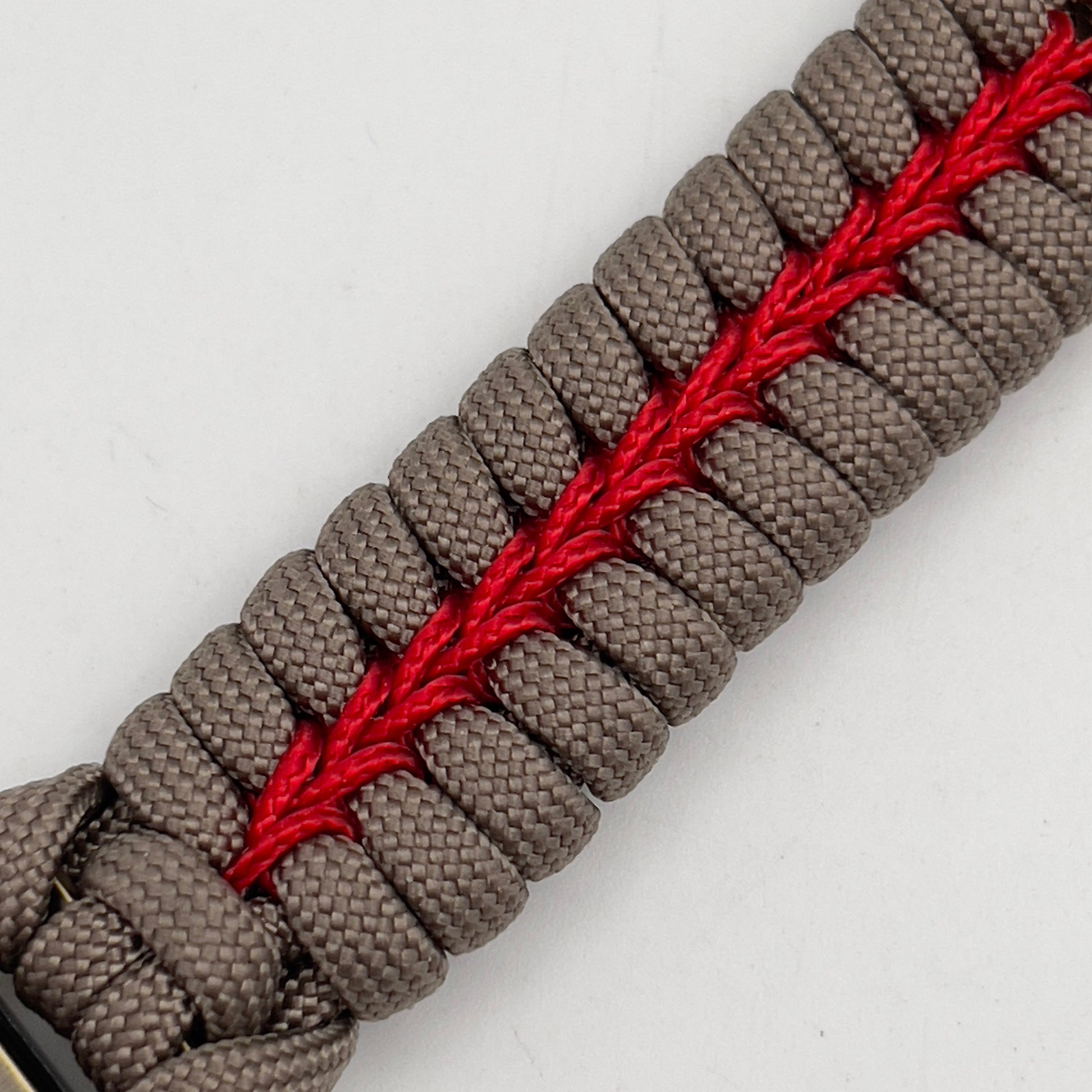 Thick, semi-rigid and comfortable braided United States Marine Corps bracelet featuring a 24K gold and silver plated USMC officer Eagle Globe and Anchor medallion, a gold Cobra style tactical buckle and woven with tan 550 paracord and Imperial red micro cord.