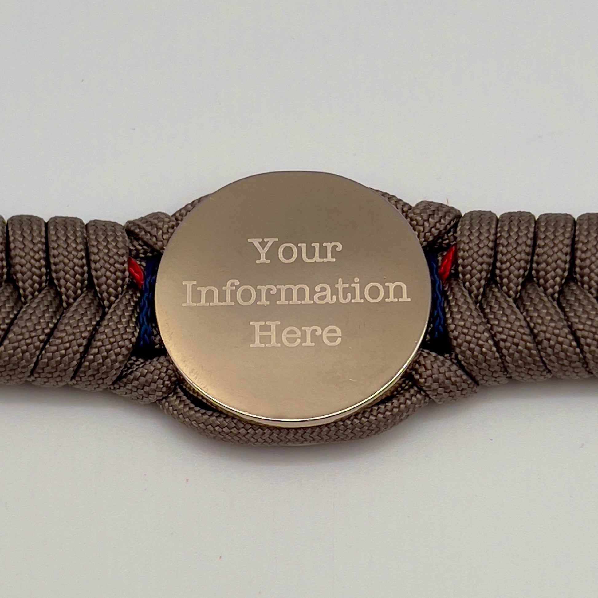 Thick, semi-rigid and comfortable braided United States Marine Corps bracelet featuring a 24K gold and silver plated USMC officer Eagle Globe and Anchor medallion, a gold Cobra style tactical buckle and woven with tan 550 paracord and Imperial red and gold micro cord.