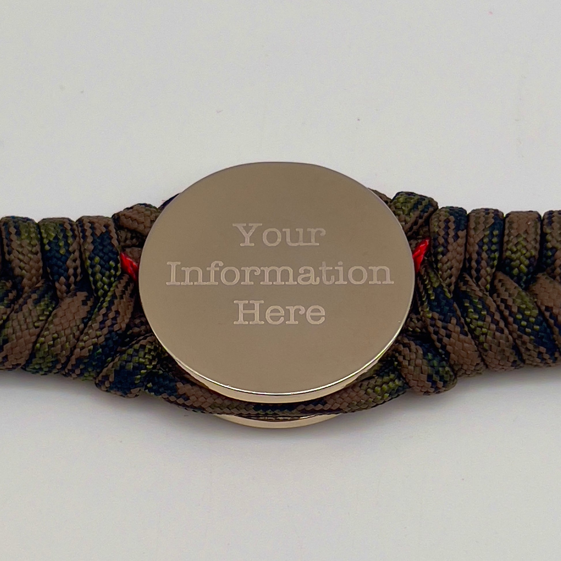 Thick, semi-rigid and comfortable braided United States Marine Corps bracelet featuring a 24K gold and silver plated USMC officer Eagle Globe and Anchor medallion, a gold Cobra style tactical buckle and woven with Woodland Camo 550 paracord and Imperial Red micro cord.