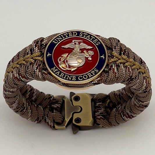 Thick and comfortable braided United States Marine Corps bracelet featuring a 24K gold and silver plated USMC officer Eagle Globe and Anchor medallion, a Cobra style tactical buckle and woven with Desert Camo 550 paracord gold micro cord.