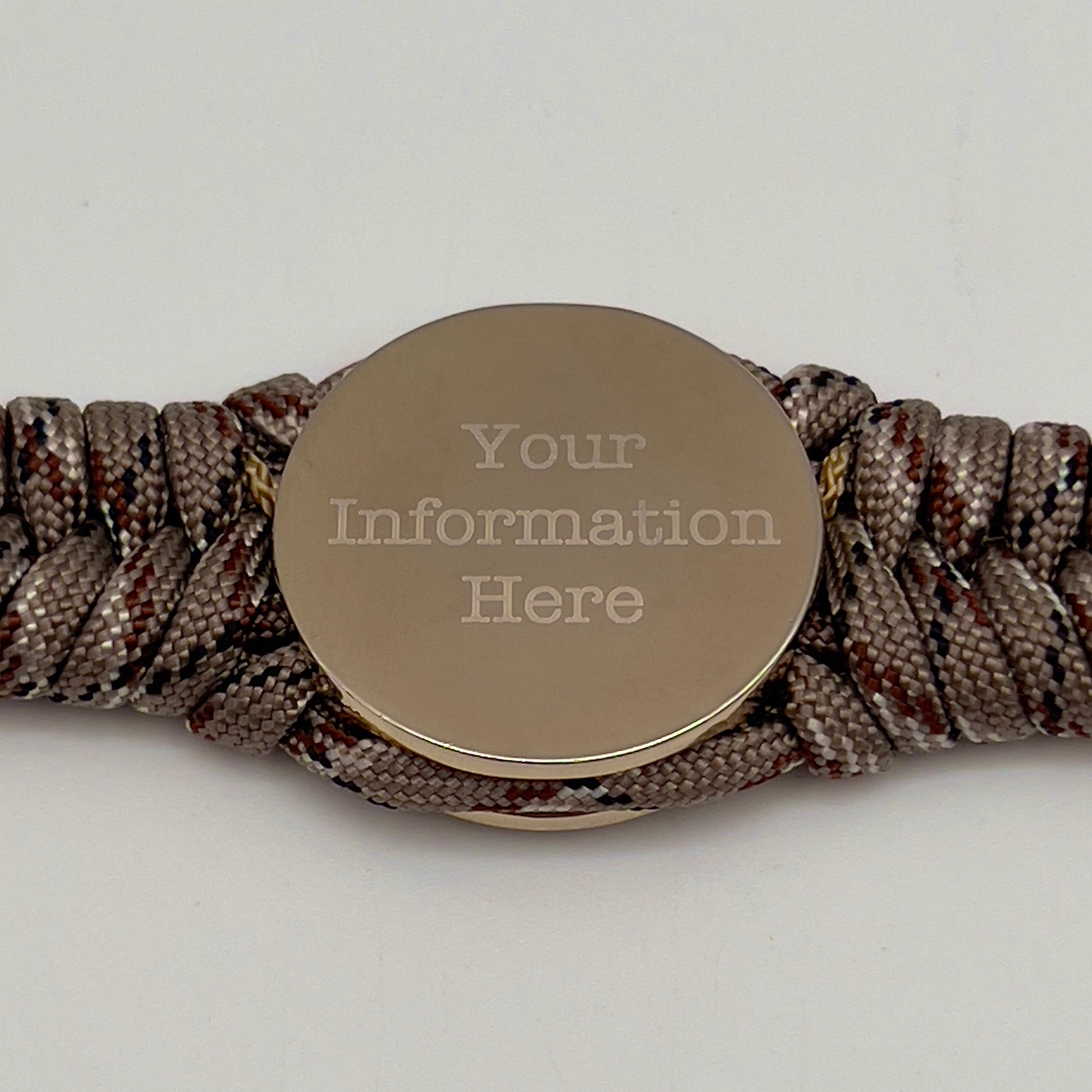 Thick and comfortable braided United States Marine Corps bracelet featuring a 24K gold and silver plated USMC officer Eagle Globe and Anchor medallion, a Cobra style tactical buckle and woven with Desert Camo 550 paracord gold micro cord.