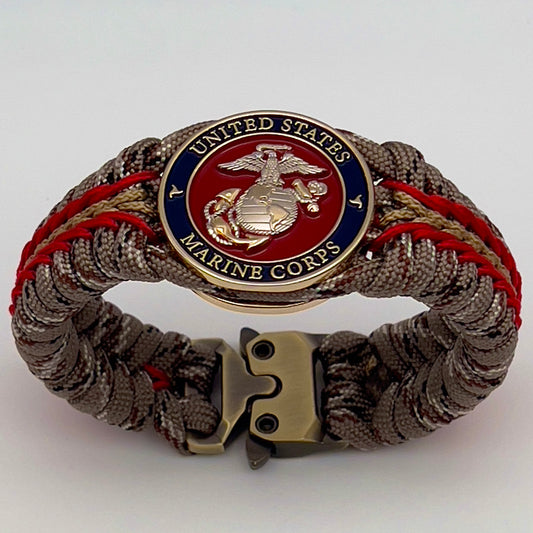 Thick and comfortable braided United States Marine Corps bracelet featuring a 24K gold and silver plated USMC officer Eagle Globe and Anchor medallion, a Cobra style tactical buckle and woven with Desert Camo 550 paracord and Imperial red and gold micro cord.