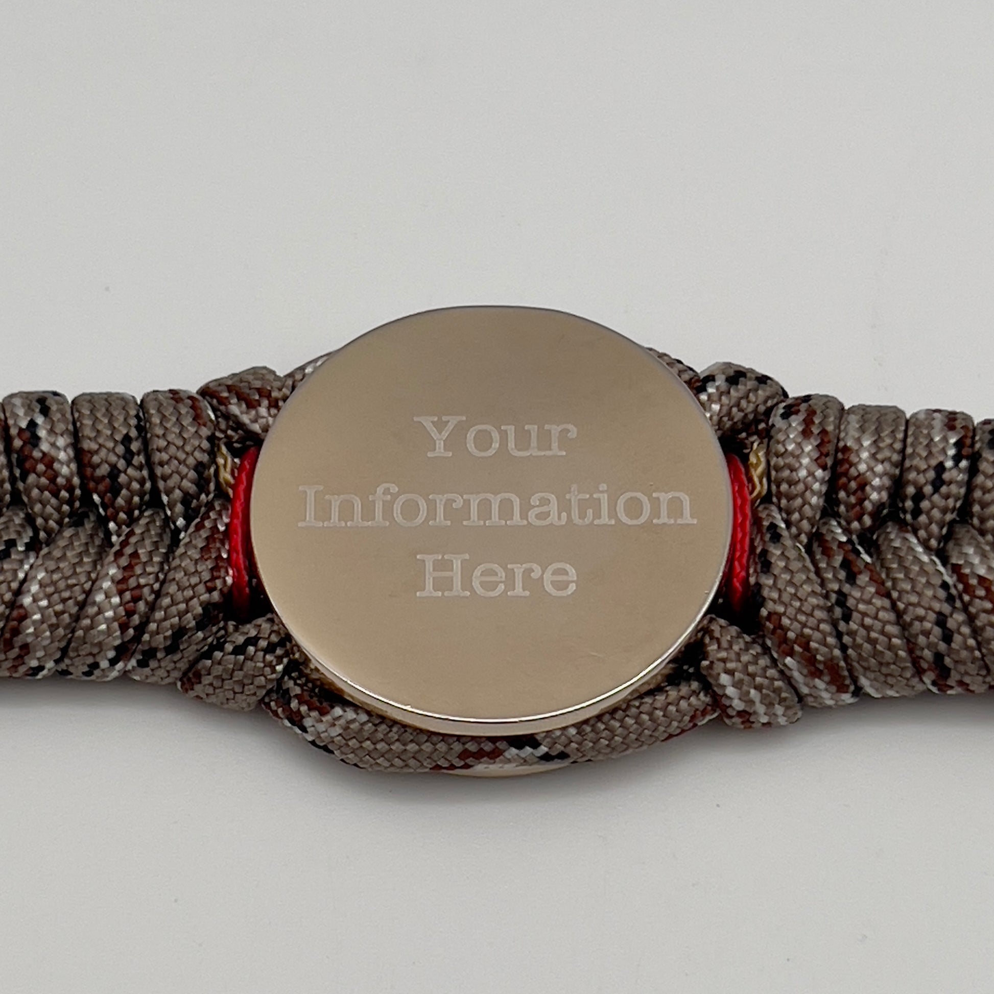 Thick and comfortable braided United States Marine Corps bracelet featuring a 24K gold and silver plated USMC officer Eagle Globe and Anchor medallion, a Cobra style tactical buckle and woven with Desert Camo 550 paracord and Imperial red and gold micro cord.