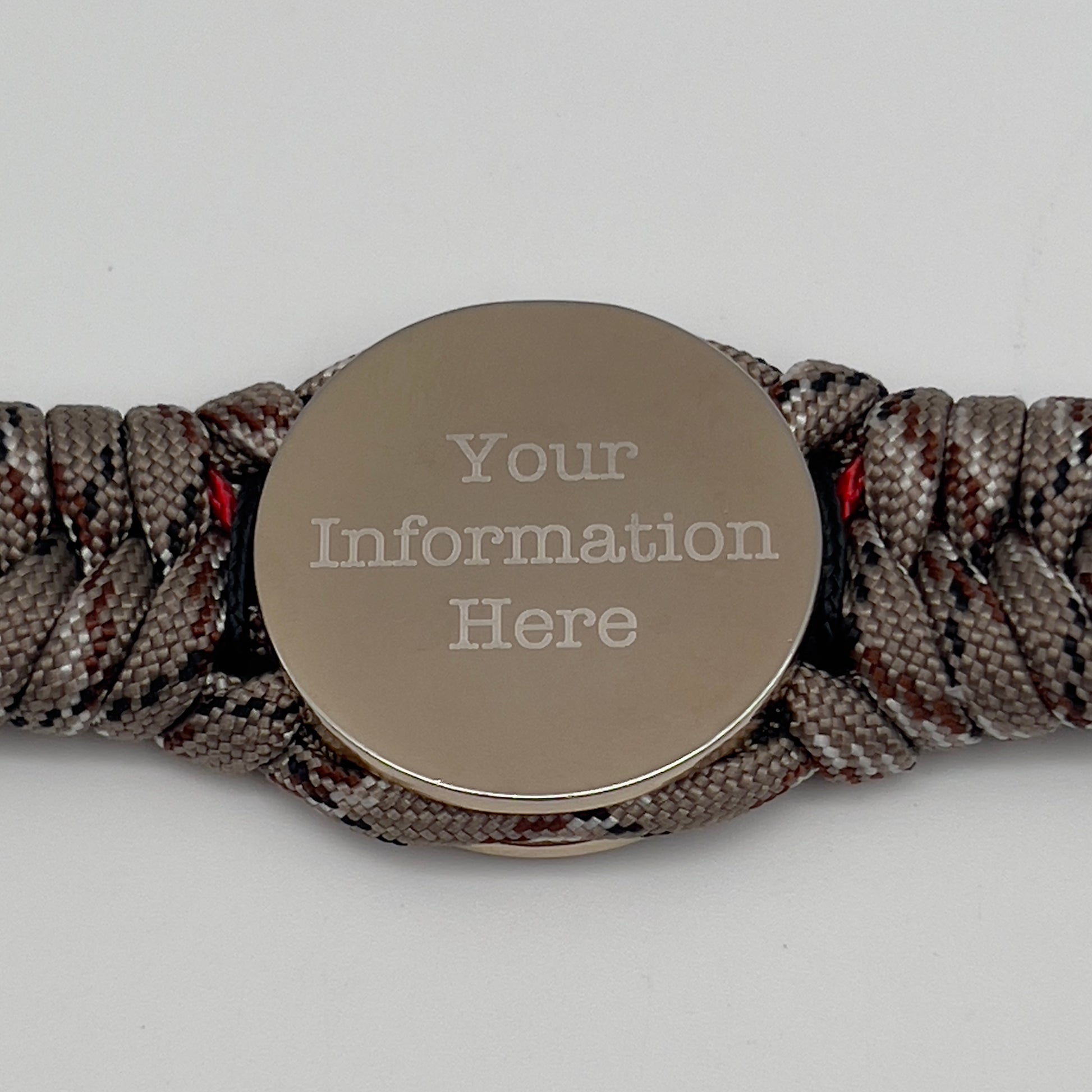 Thick and comfortable braided United States Marine Corps bracelet featuring a 24K gold and silver plated USMC officer Eagle Globe and Anchor medallion, a Cobra style tactical buckle and woven with Desert Camo 550 paracord and Imperial red and black micro cord.