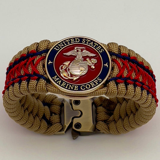 Thick and comfortable braided United States Marine Corps bracelet featuring a 24K gold and silver plated USMC officer Eagle Globe and Anchor medallion, a gold Cobra style tactical buckle and woven with gold 550 paracord and Imperial Red and Navy Blue micro cord.