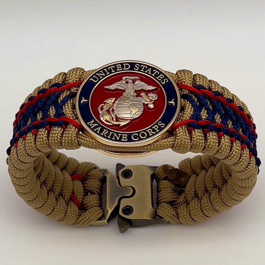 Thick and comfortable braided United States Marine Corps bracelet featuring a 24K gold and silver plated USMC officer Eagle Globe and Anchor medallion, a gold Cobra style tactical buckle and woven with gold 550 paracord and Imperial Red and Navy Blue micro cord.