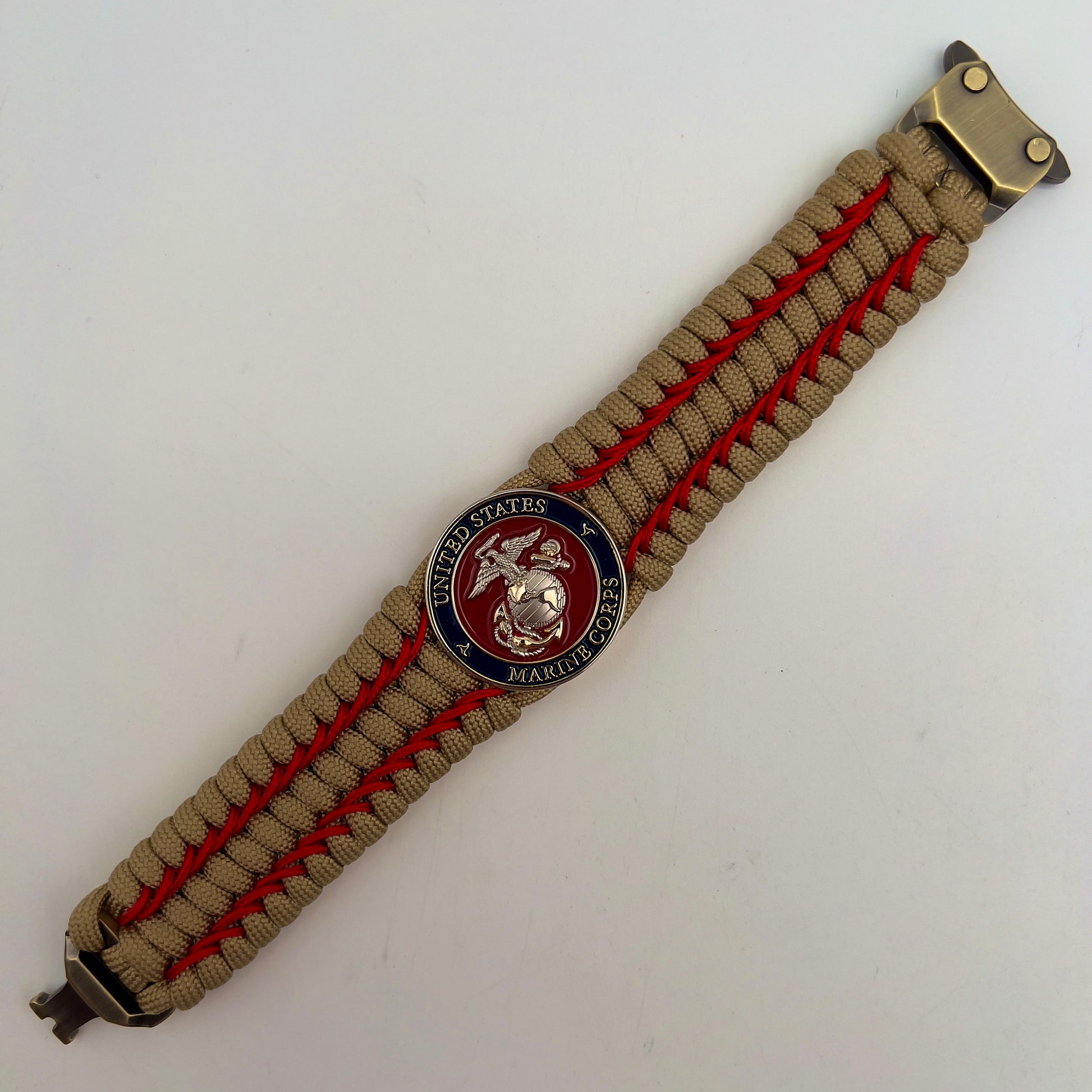 Thick and comfortable braided United States Marine Corps bracelet featuring a 24K gold and silver plated USMC officer Eagle Globe and Anchor medallion, a gold Cobra style tactical buckle and woven with gold 550 paracord and Imperial Red micro cord.