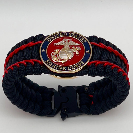 Thick and comfortable braided United States Marine Corps bracelet featuring a 24K gold and silver plated USMC officer Eagle Globe and Anchor medallion, a black Cobra style tactical buckle and woven with black 550 paracord and Imperial Red micro cord.