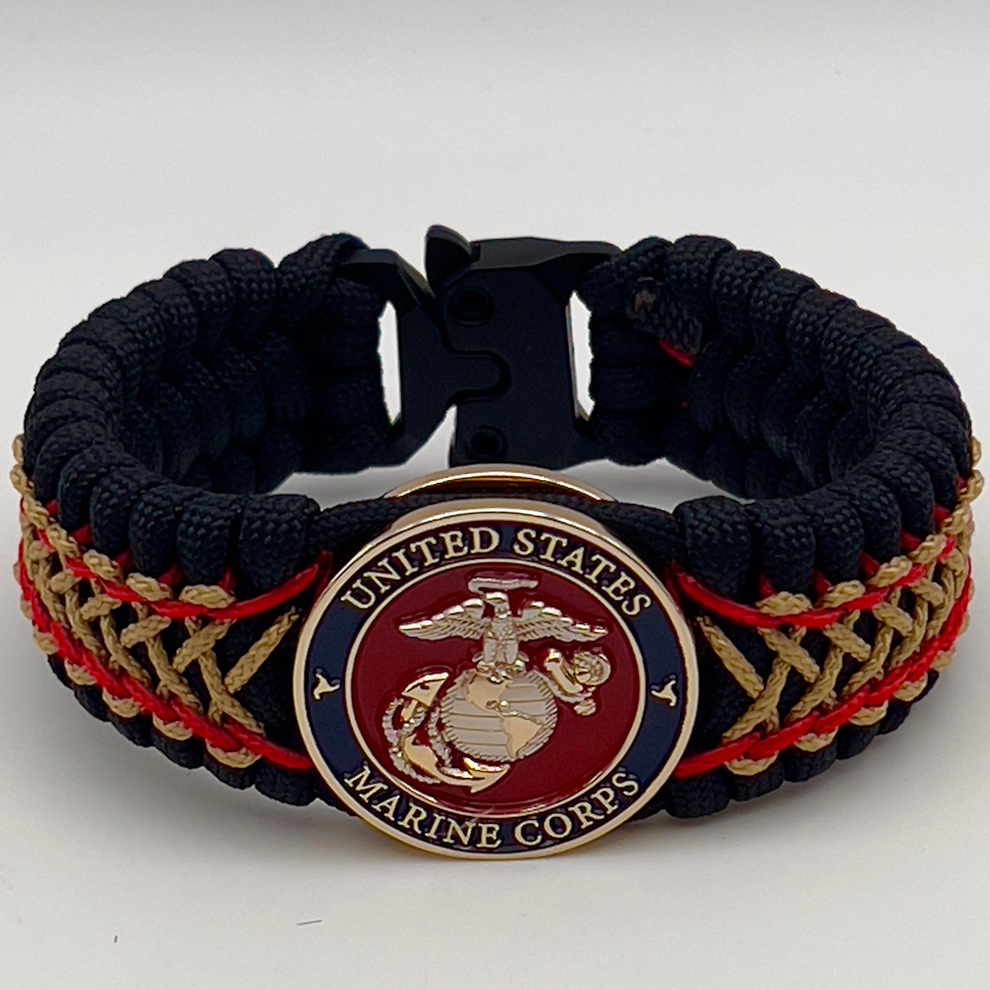 Thick and comfortable braided United States Marine Corps bracelet featuring a 24K gold and silver plated USMC officer Eagle Globe and Anchor medallion, a black Cobra style tactical buckle and woven with black 550 paracord and Imperial Red and gold micro cord.