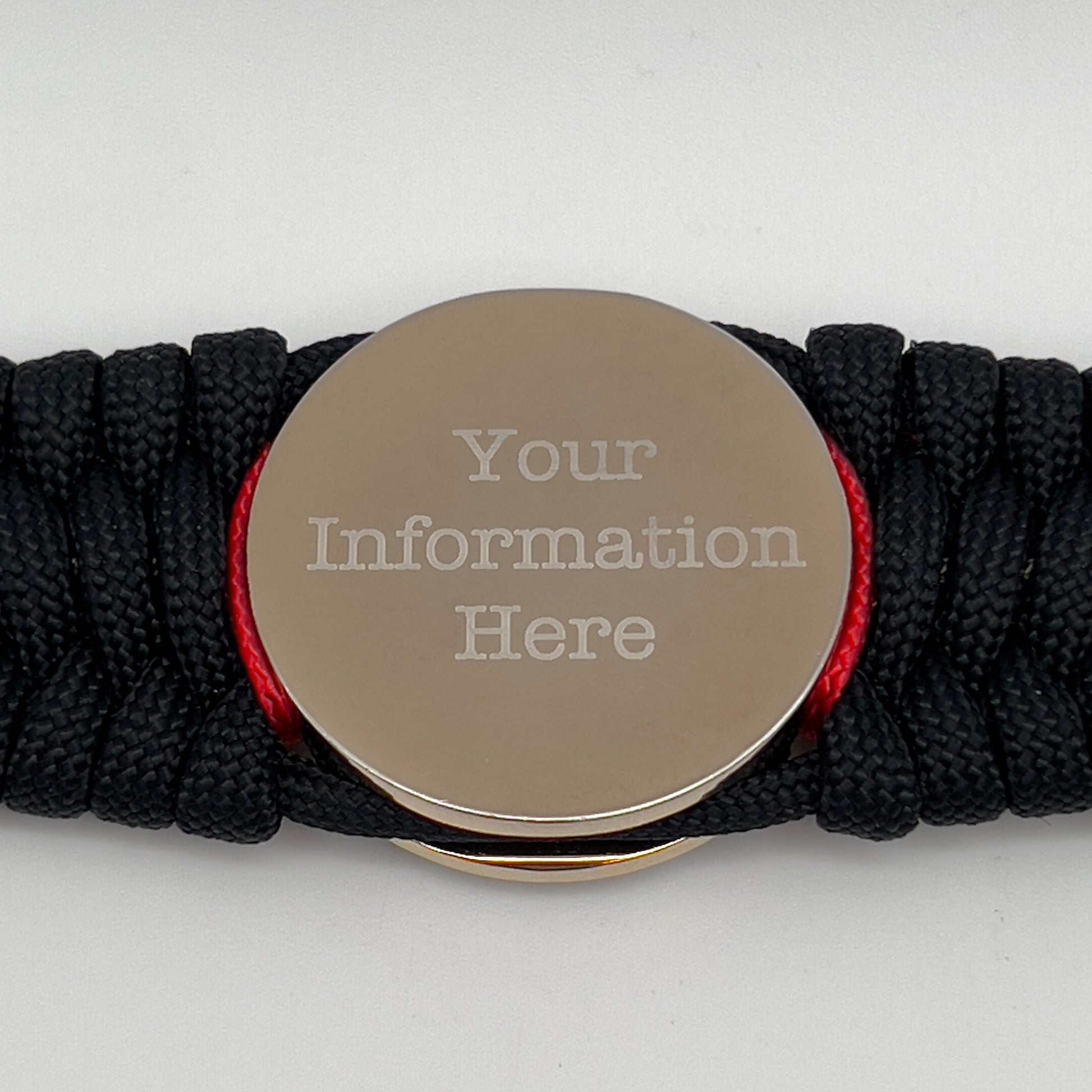 Thick and comfortable braided United States Marine Corps bracelet featuring a 24K gold and silver plated USMC officer Eagle Globe and Anchor medallion, a black Cobra style tactical buckle and woven with black 550 paracord and Imperial Red and gold micro cord.