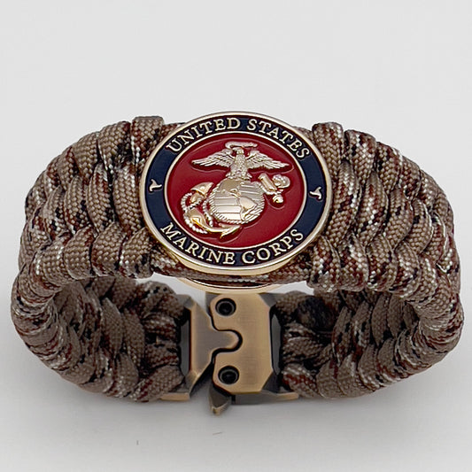 Thick and comfortable braided United States Marine Corps bracelet featuring a 24K gold and silver plated USMC officer Eagle Globe and Anchor medallion, a gold Cobra style tactical buckle and woven with Desert Camo 550 paracord.