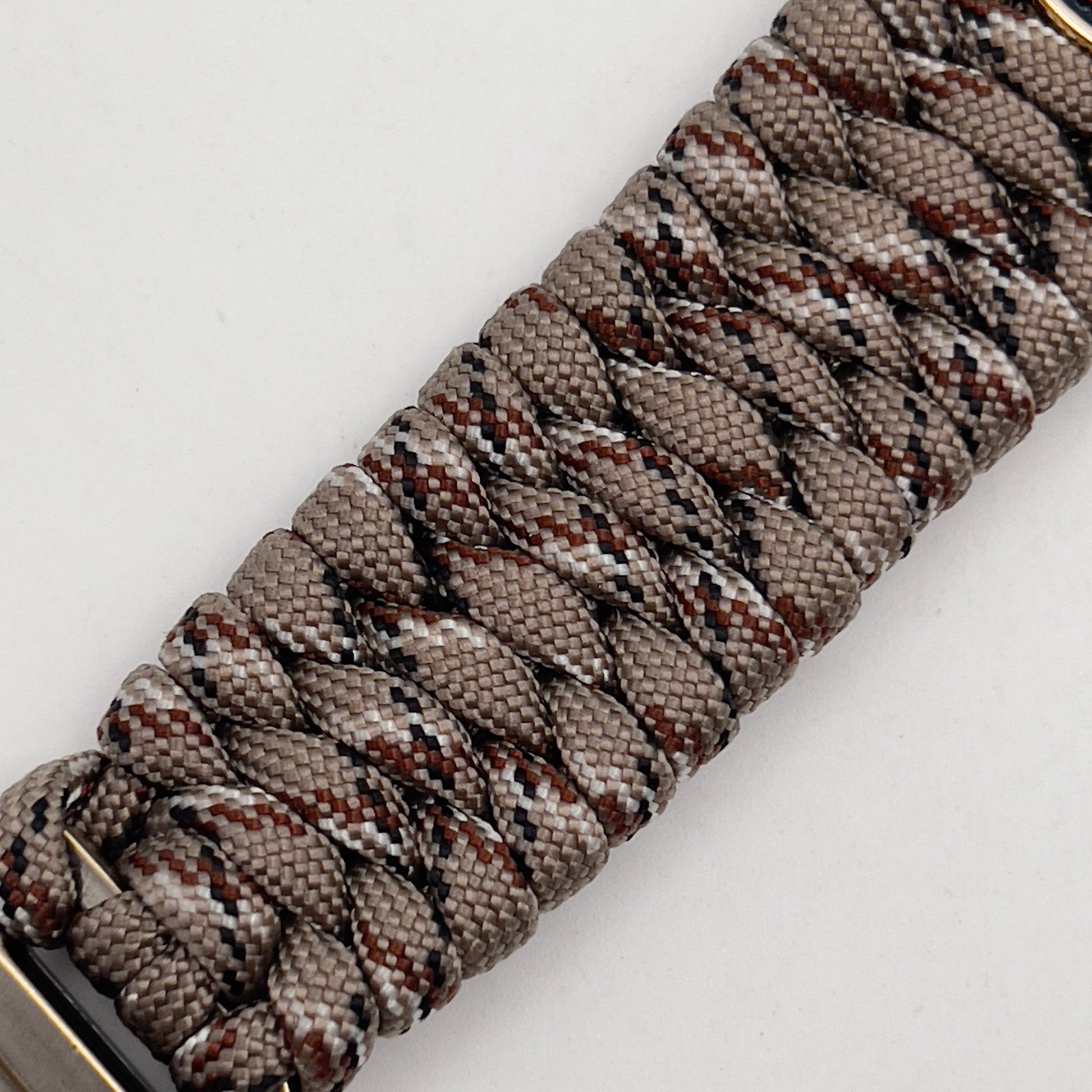 Thick and comfortable braided United States Marine Corps bracelet featuring a 24K gold and silver plated USMC officer Eagle Globe and Anchor medallion, a gold Cobra style tactical buckle and woven with Desert Camo 550 paracord.