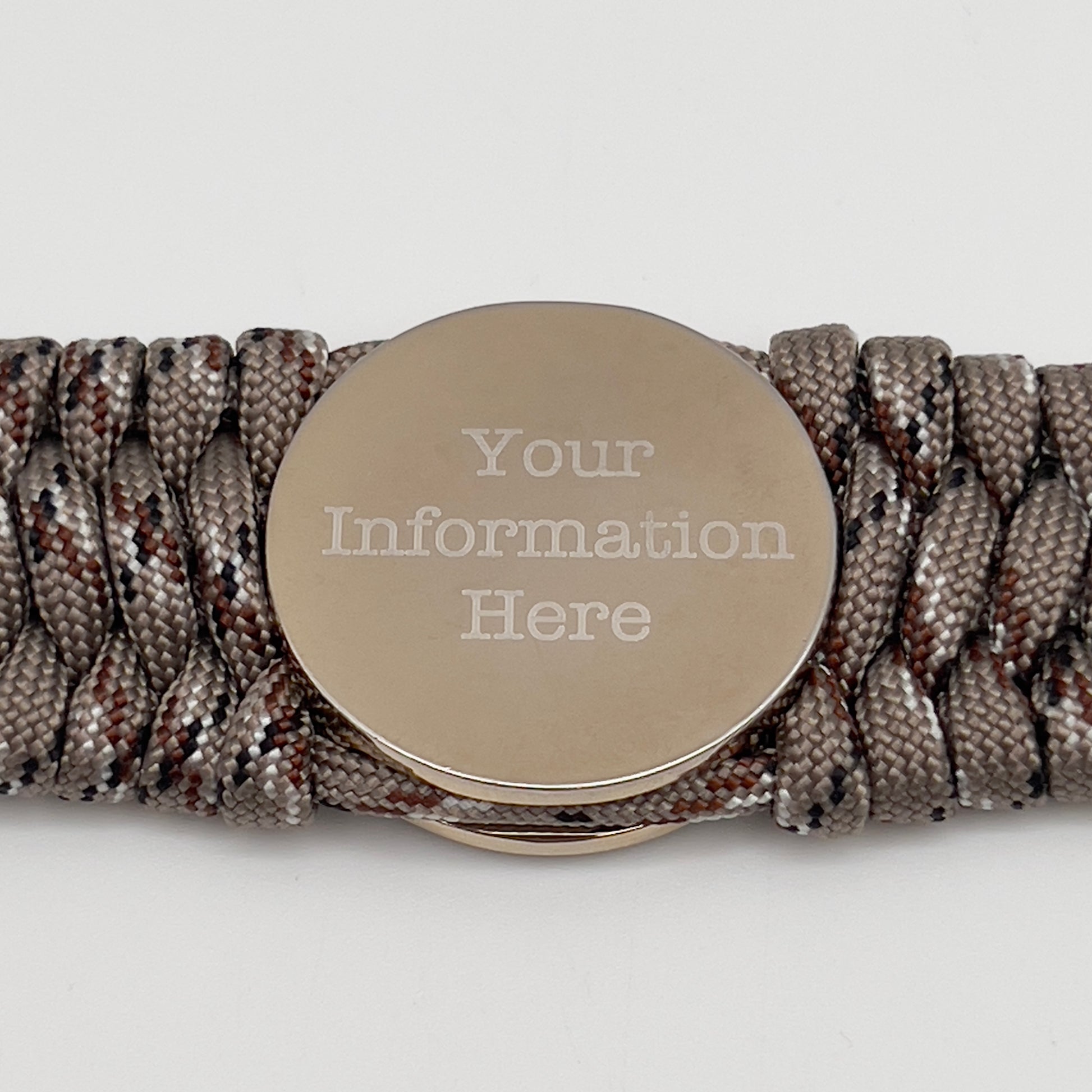 Thick and comfortable braided United States Marine Corps bracelet featuring a 24K gold and silver plated USMC officer Eagle Globe and Anchor medallion, a gold Cobra style tactical buckle and woven with Desert Camo 550 paracord.
