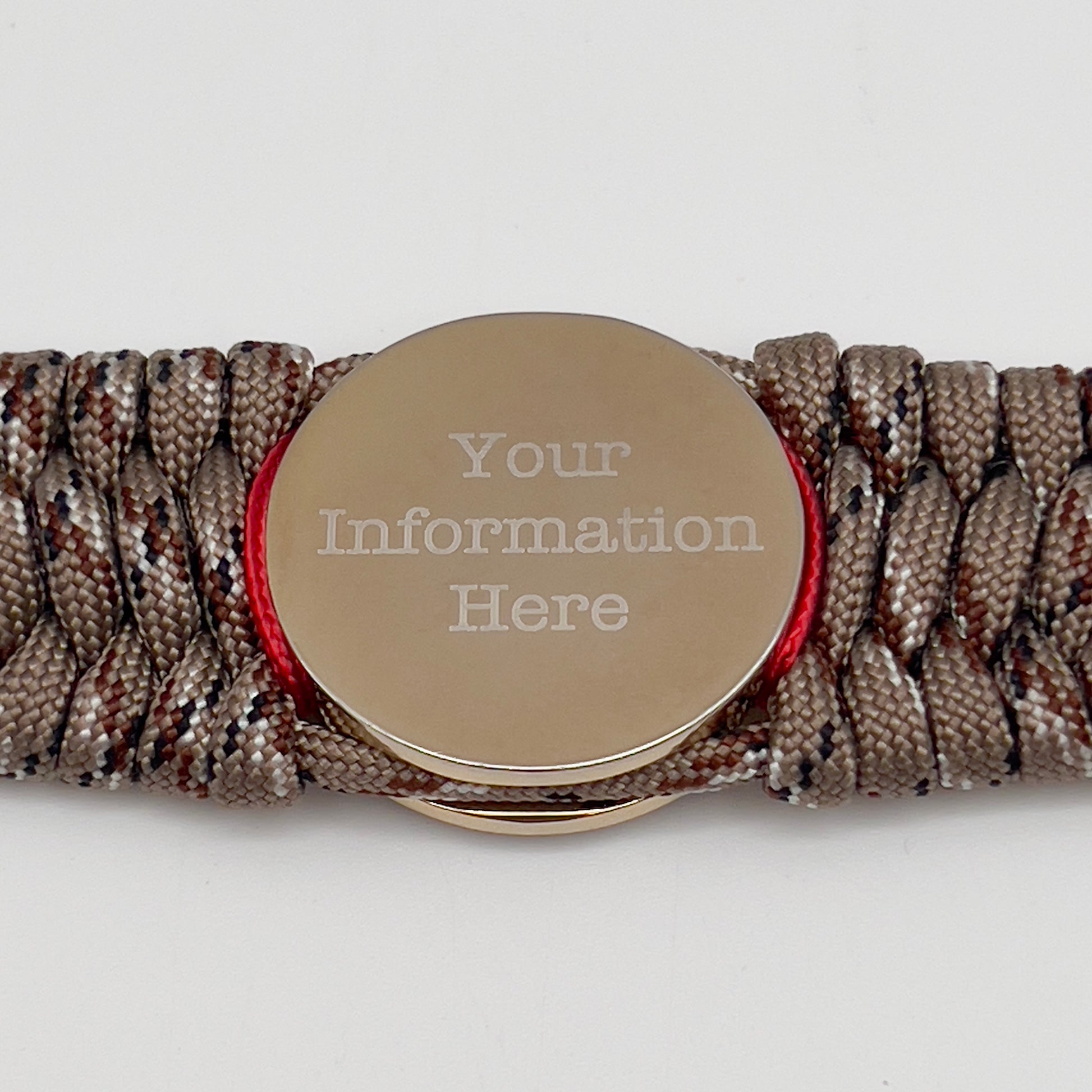 Thick and comfortable braided United States Marine Corps bracelet featuring a 24K gold and silver plated USMC officer Eagle Globe and Anchor medallion, a gold Cobra style tactical buckle and woven with Desert Camo 550 paracord and Imperial Red micro cord.