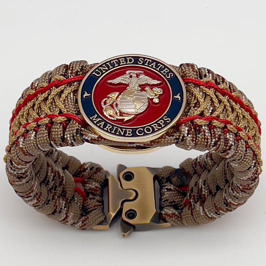Thick and comfortable braided United States Marine Corps bracelet featuring a 24K gold and silver plated USMC officer Eagle Globe and Anchor medallion, a gold Cobra style tactical buckle and woven with Desert Camo 550 paracord and Imperial Red and Gold micro cord.
