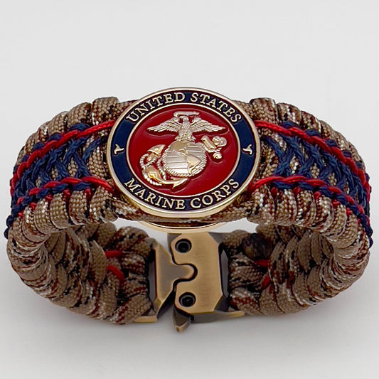 Thick and comfortable braided United States Marine Corps bracelet featuring a 24K gold and silver plated USMC officer Eagle Globe and Anchor medallion, a gold Cobra style tactical buckle and woven with Desert Camo 550 paracord and Imperial Red and Navy Blue micro cord.
