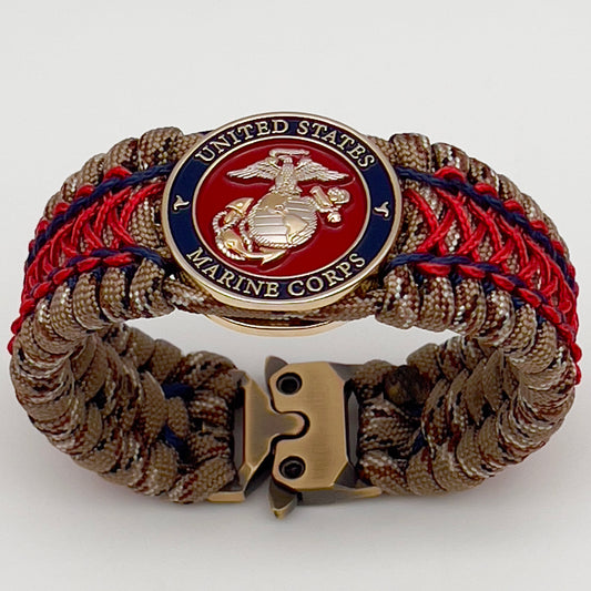 Thick and comfortable braided United States Marine Corps bracelet featuring a 24K gold and silver plated USMC officer Eagle Globe and Anchor medallion, a gold Cobra style tactical buckle and woven with Desert Camo 550 paracord and Imperial Red and Navy Blue micro cord.
