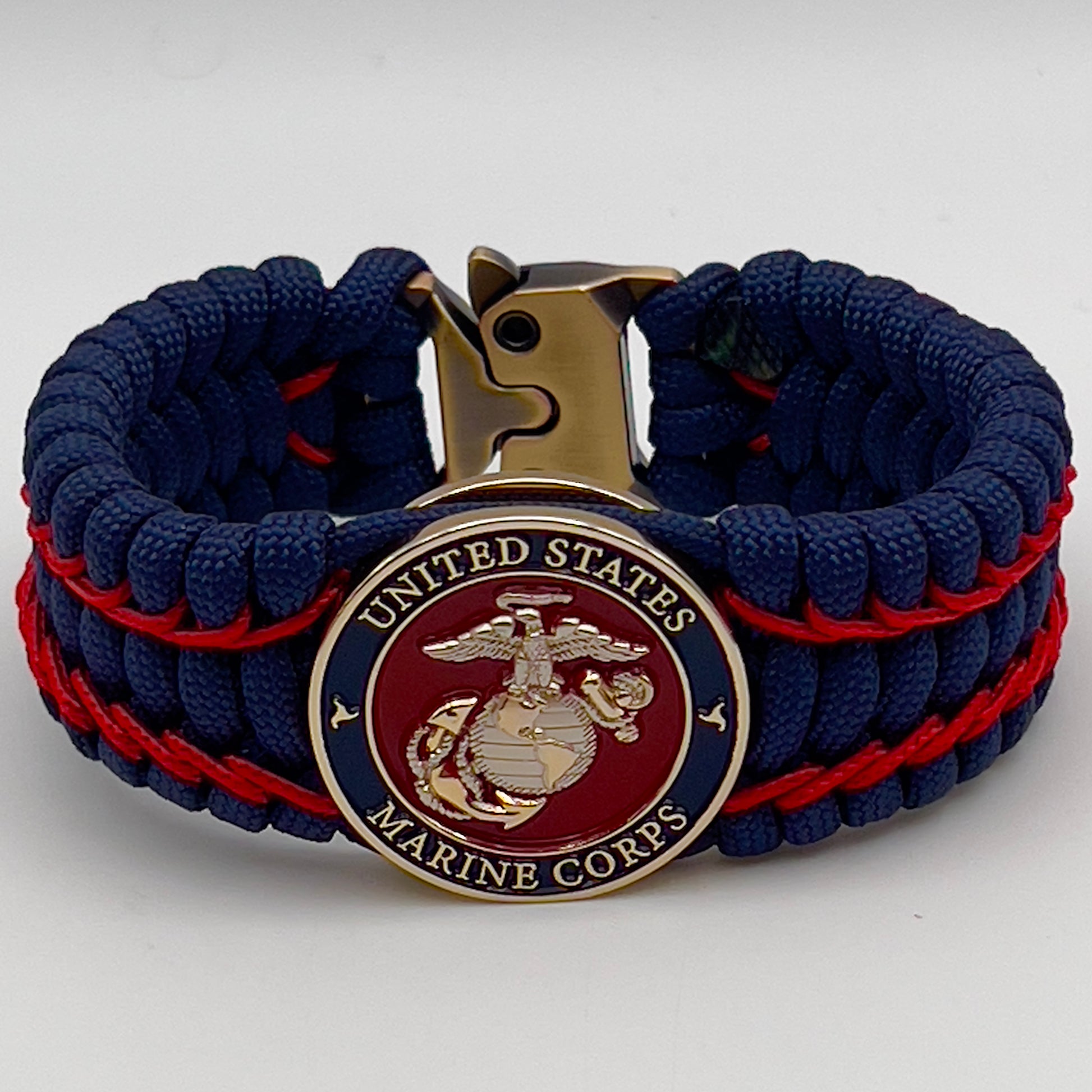 Thick and comfortable braided United States Marine Corps bracelet featuring a 24K gold and silver plated USMC officer Eagle Globe and Anchor medallion, a Cobra style tactical buckle and woven with gold 550 paracord and Imperial Red micro cord.