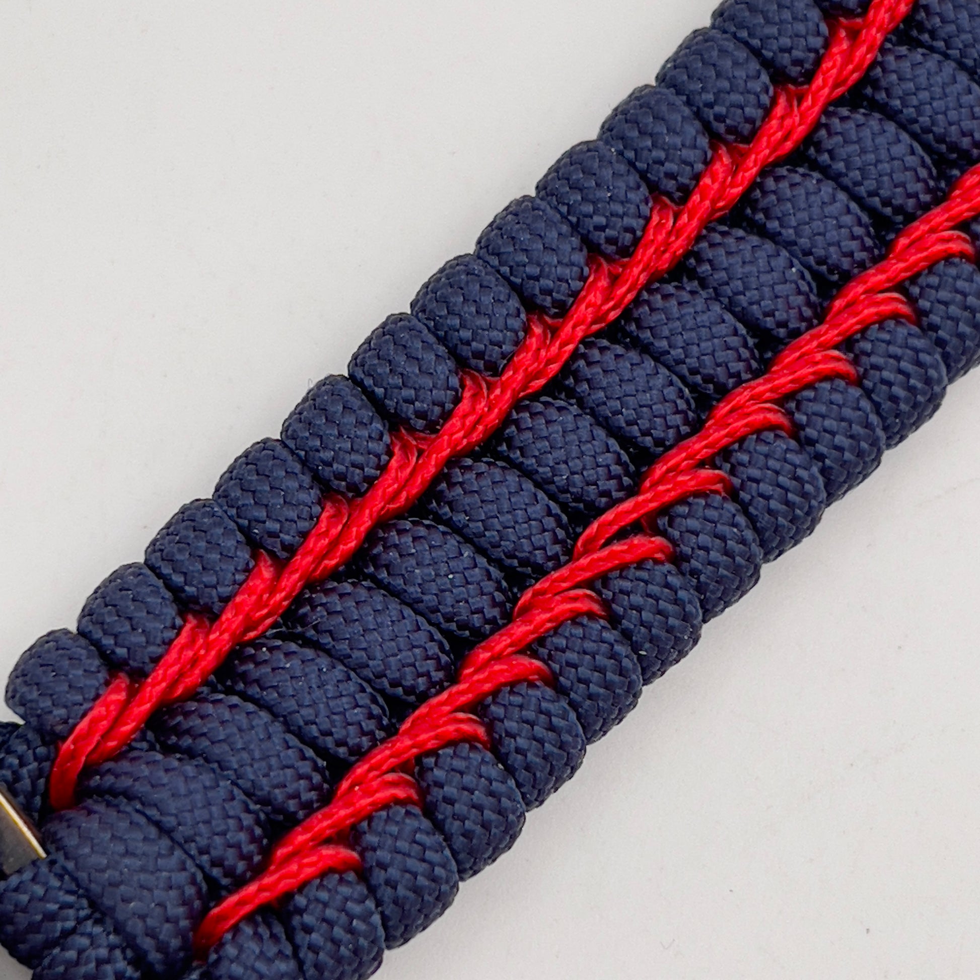 Thick and comfortable braided United States Marine Corps bracelet featuring a 24K gold and silver plated USMC officer Eagle Globe and Anchor medallion, a Cobra style tactical buckle and woven with gold 550 paracord and Imperial Red micro cord.