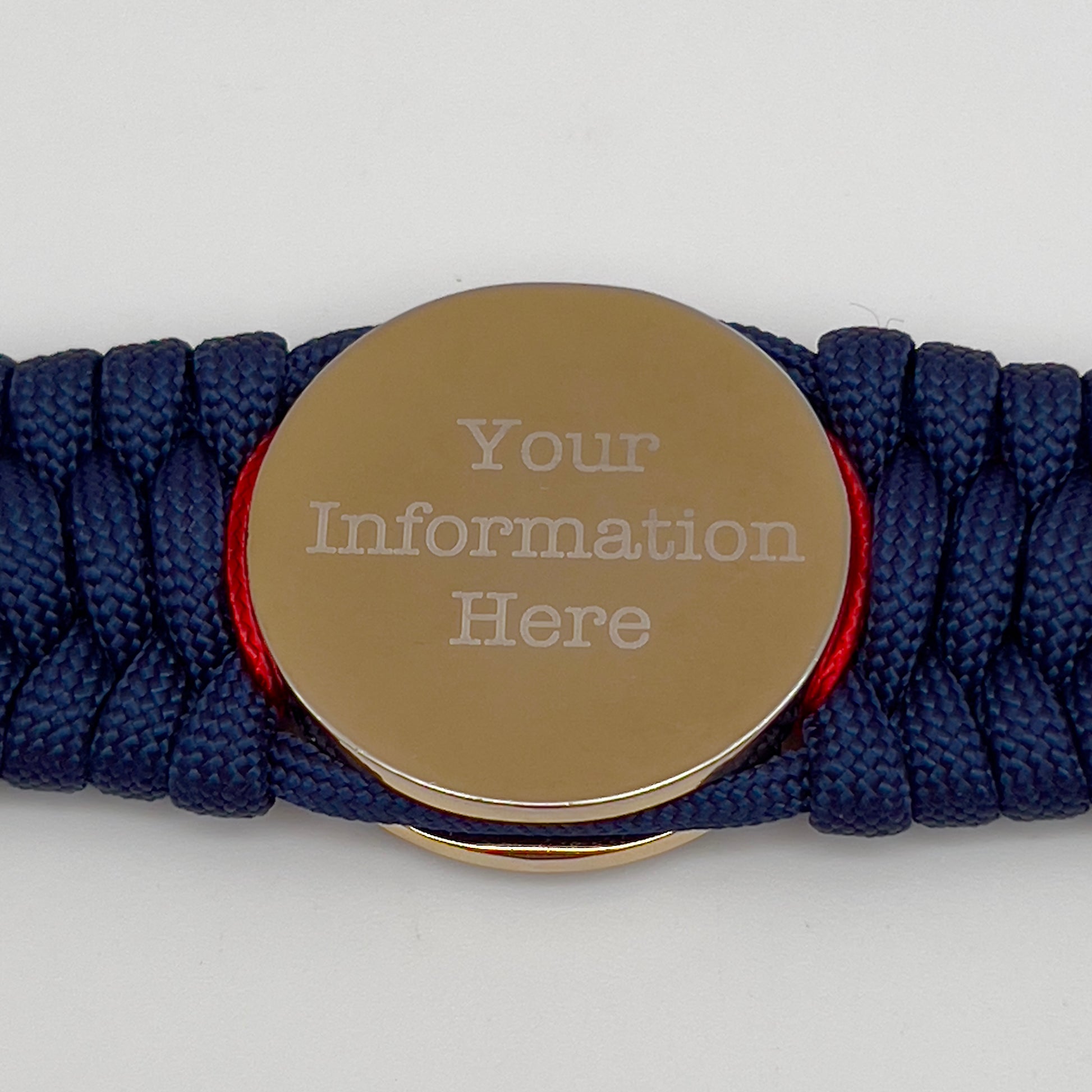 Thick and comfortable braided United States Marine Corps bracelet featuring a 24K gold and silver plated USMC officer Eagle Globe and Anchor medallion, a Cobra style tactical buckle and woven with gold 550 paracord and Imperial Red and Black micro cord.