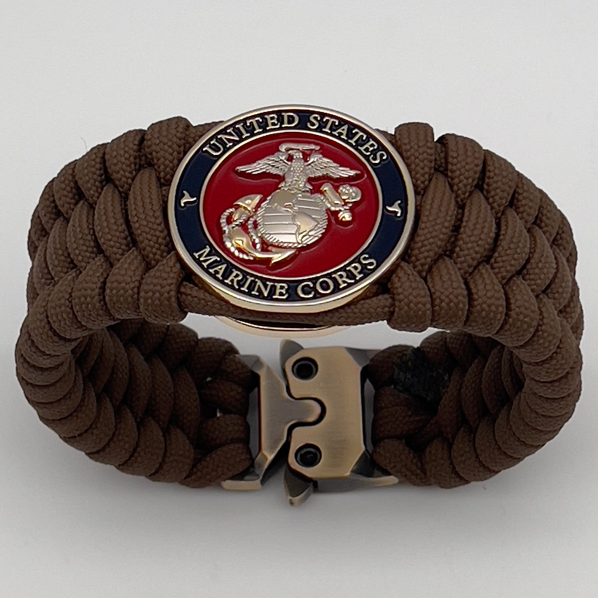 Thick and comfortable braided United States Marine Corps bracelet featuring a 24K gold and silver plated USMC officer Eagle Globe and Anchor medallion, a Cobra style tactical buckle and woven with Coyote Brown 550 paracord.