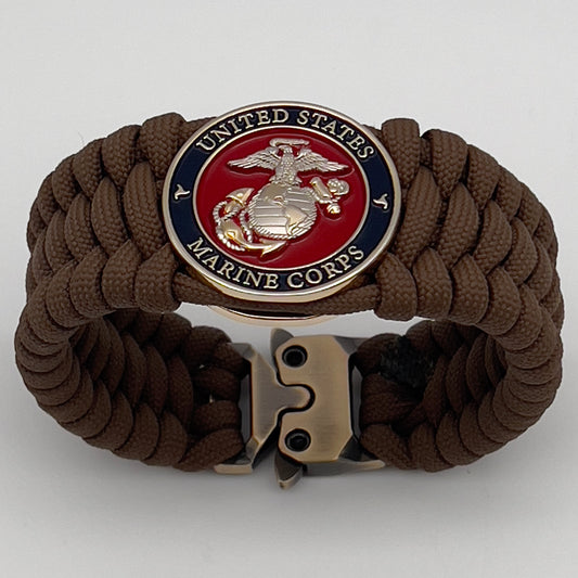 Thick and comfortable braided United States Marine Corps bracelet featuring a 24K gold and silver plated USMC officer Eagle Globe and Anchor medallion, a Cobra style tactical buckle and woven with Coyote Brown 550 paracord.