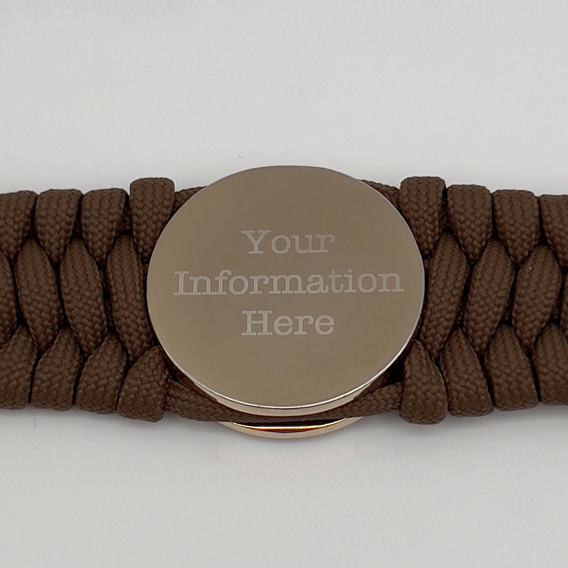 Thick and comfortable braided United States Marine Corps bracelet featuring a 24K gold and silver plated USMC officer Eagle Globe and Anchor medallion, a Cobra style tactical buckle and woven with Coyote Brown 550 paracord.