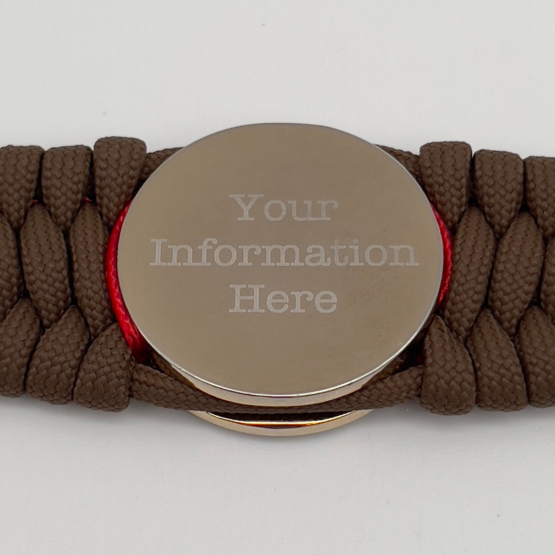 Thick and comfortable braided United States Marine Corps bracelet featuring a 24K gold and silver plated USMC officer Eagle Globe and Anchor medallion, a Cobra style tactical buckle and woven with Coyote Brown 550 paracord and Imperial Red micro cord.