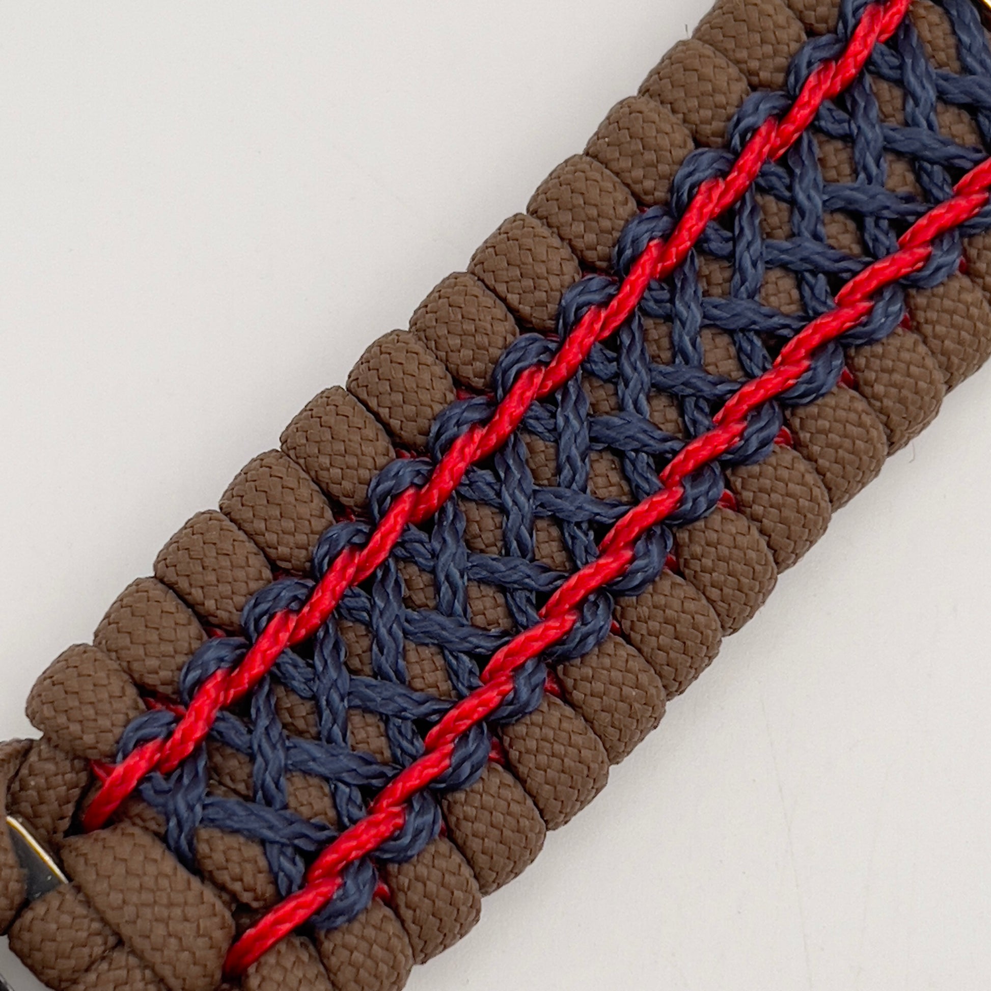 Thick and comfortable braided United States Marine Corps bracelet featuring a 24K gold and silver plated USMC officer Eagle Globe and Anchor medallion, a Cobra style tactical buckle and woven with Coyote Brown 550 paracord and Imperial Red and Navy Blue micro cord.