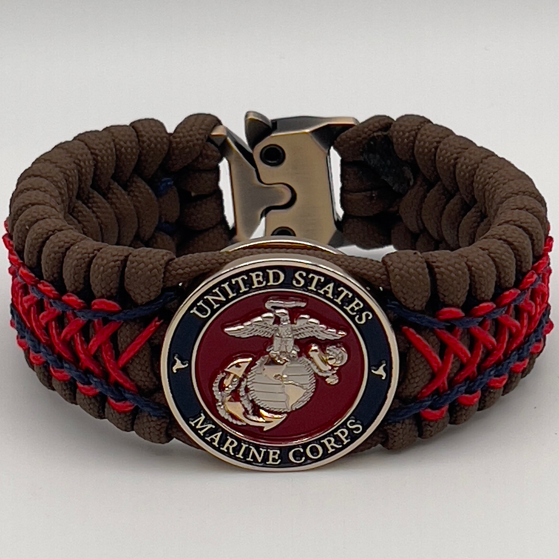Thick and comfortable braided United States Marine Corps bracelet featuring a 24K gold and silver plated USMC officer Eagle Globe and Anchor medallion, a Cobra style tactical buckle and woven with Coyote Brown 550 paracord and Imperial Red and Navy Blue micro cord.