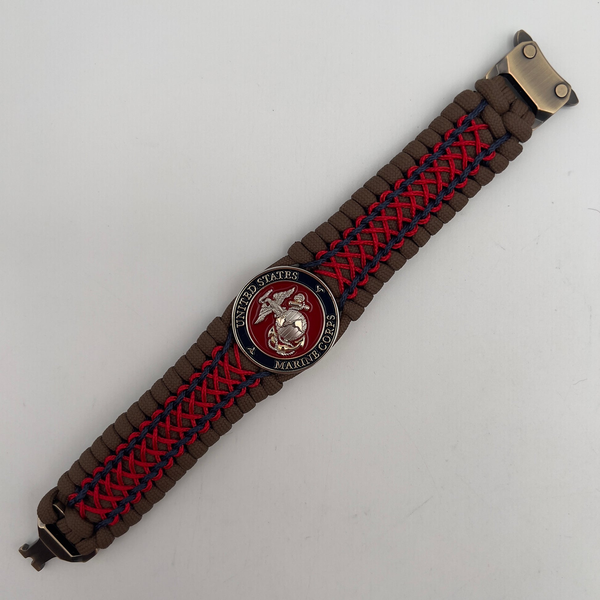Thick and comfortable braided United States Marine Corps bracelet featuring a 24K gold and silver plated USMC officer Eagle Globe and Anchor medallion, a Cobra style tactical buckle and woven with Coyote Brown 550 paracord and Imperial Red and Navy Blue micro cord.