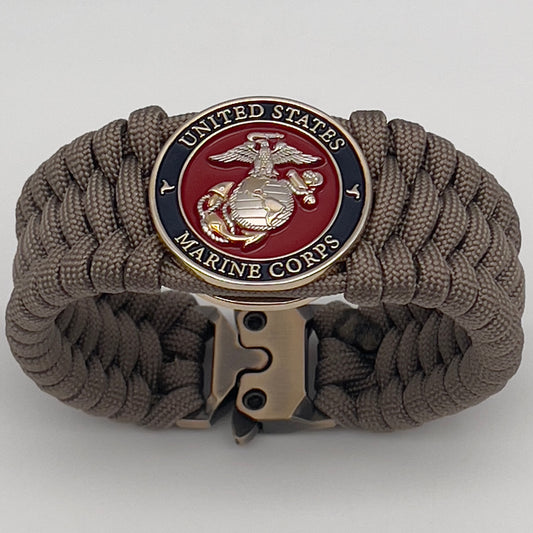Thick and comfortable braided United States Marine Corps bracelet featuring a 24K gold and silver plated USMC officer Eagle Globe and Anchor medallion, a Cobra style tactical buckle and woven with tan 550 paracord.