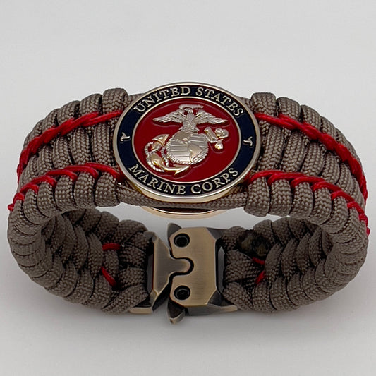 Thick, semi-rigid and comfortable braided United States Marine Corps bracelet featuring a 24K gold and silver plated USMC officer Eagle Globe and Anchor medallion, a gold Cobra style tactical buckle and woven with tan 550 paracord and Imperial Red micro cord.