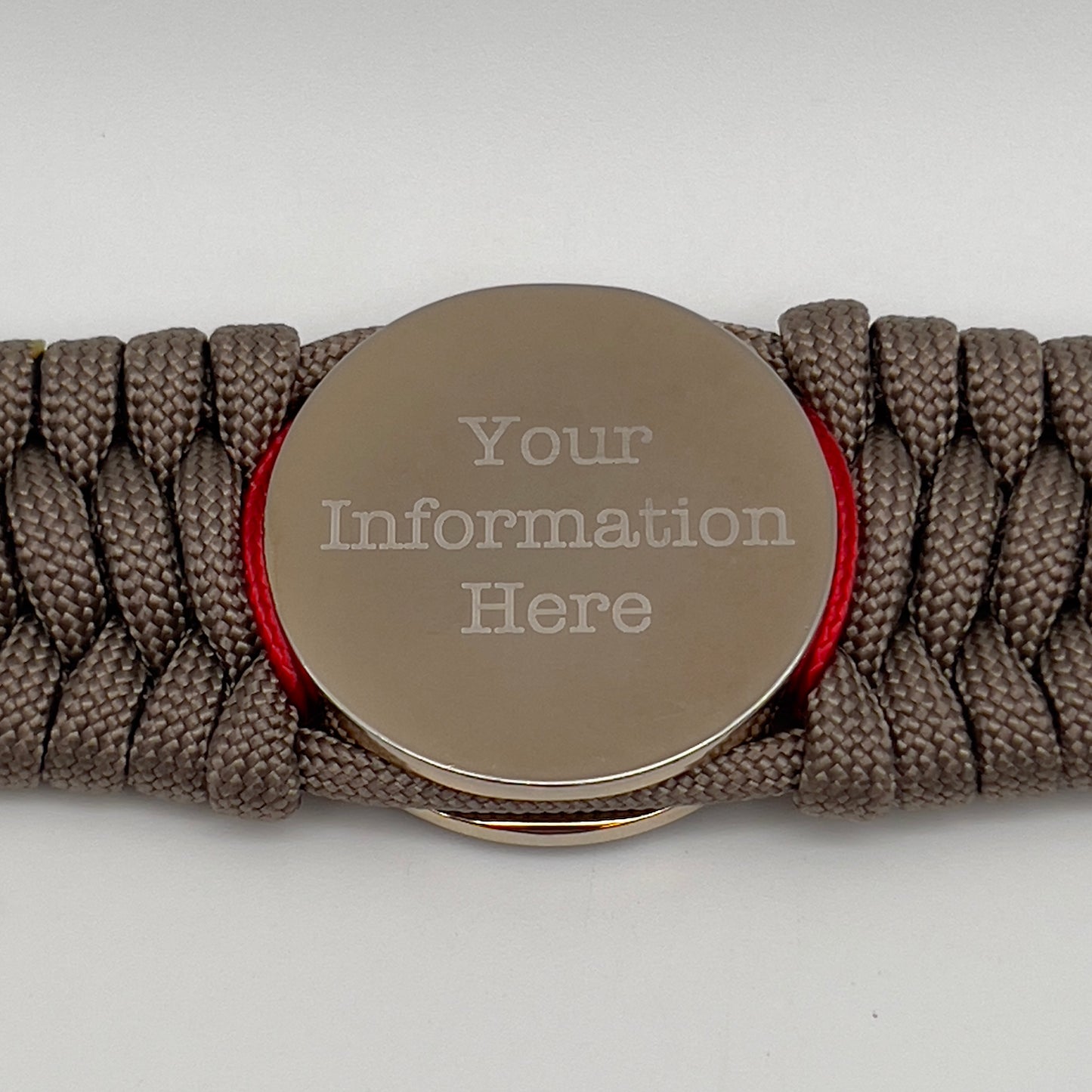 Thick, semi-rigid and comfortable braided United States Marine Corps bracelet featuring a 24K gold and silver plated USMC officer Eagle Globe and Anchor medallion, a gold Cobra style tactical buckle and woven with tan 550 paracord and Imperial Red micro cord.